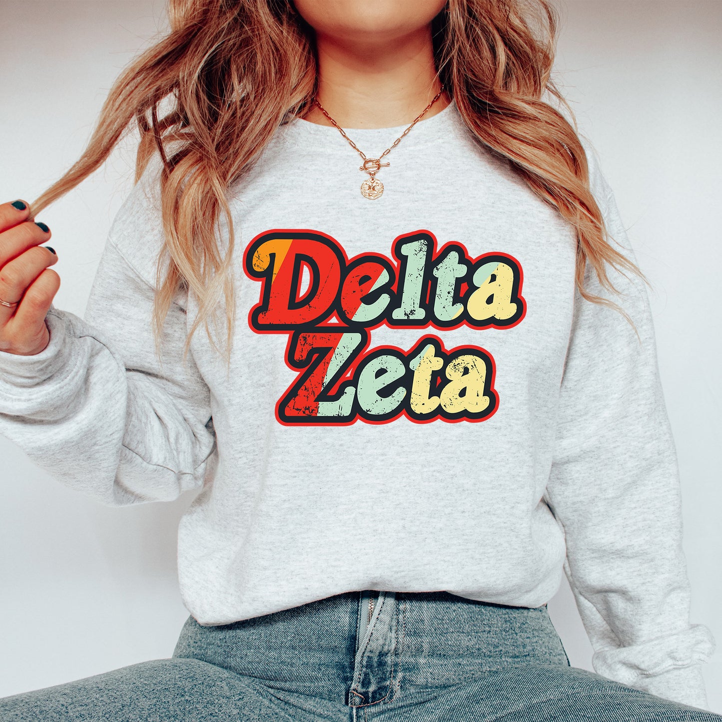 a woman wearing a sweatshirt that says delta zeta