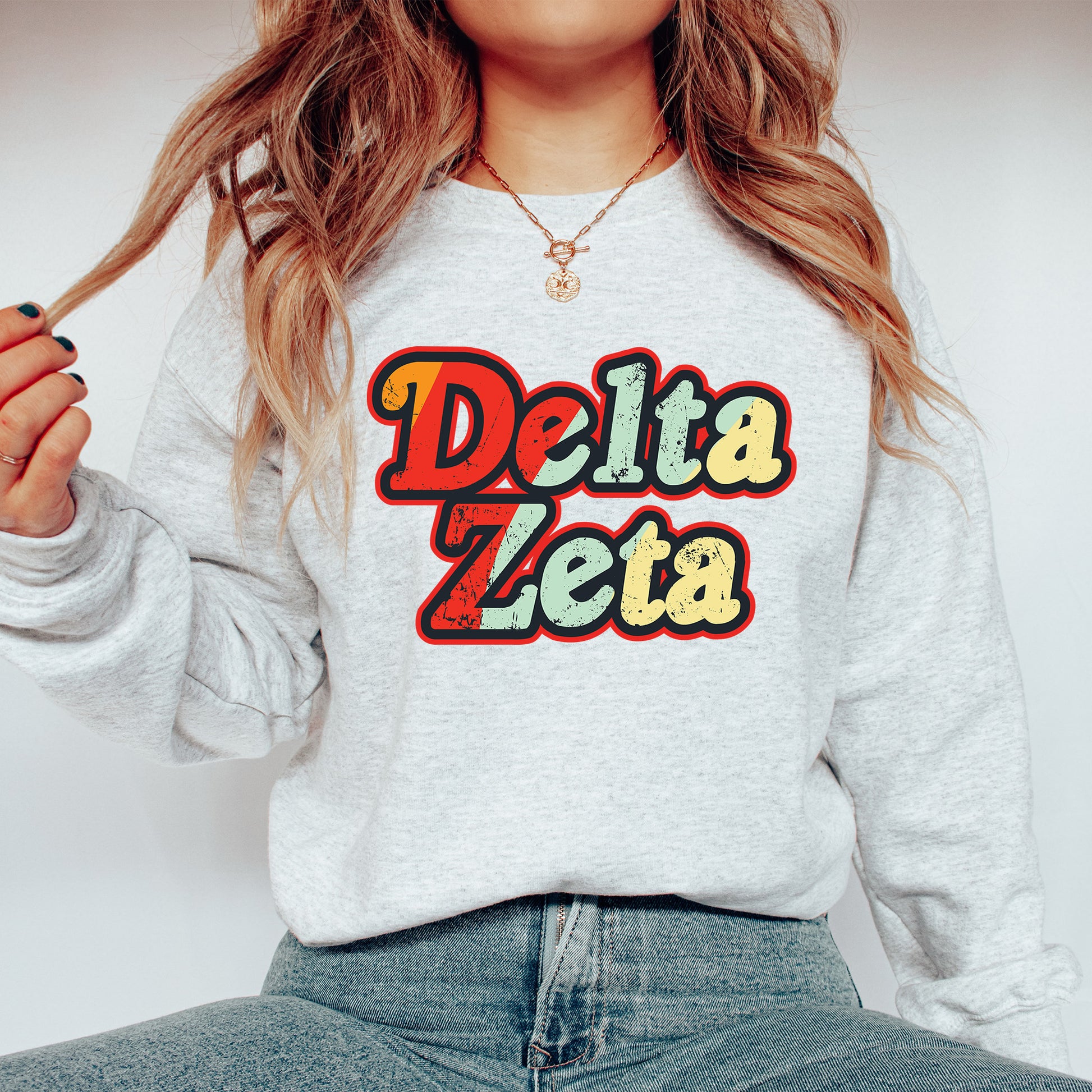 a woman wearing a sweatshirt that says delta zeta