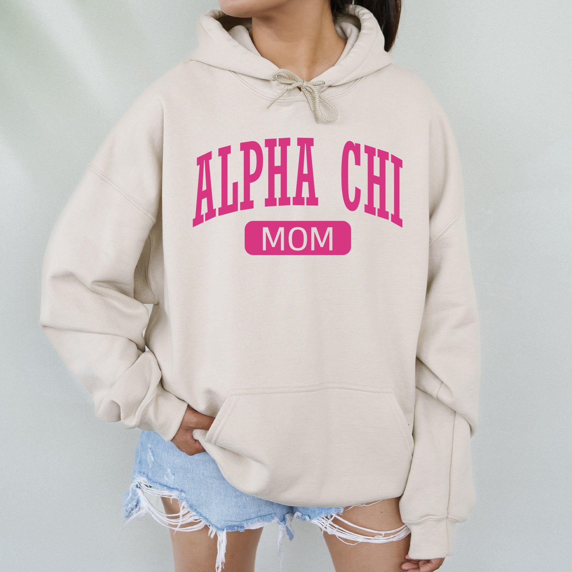 a woman wearing a sweatshirt that says,'alpha chi mom '