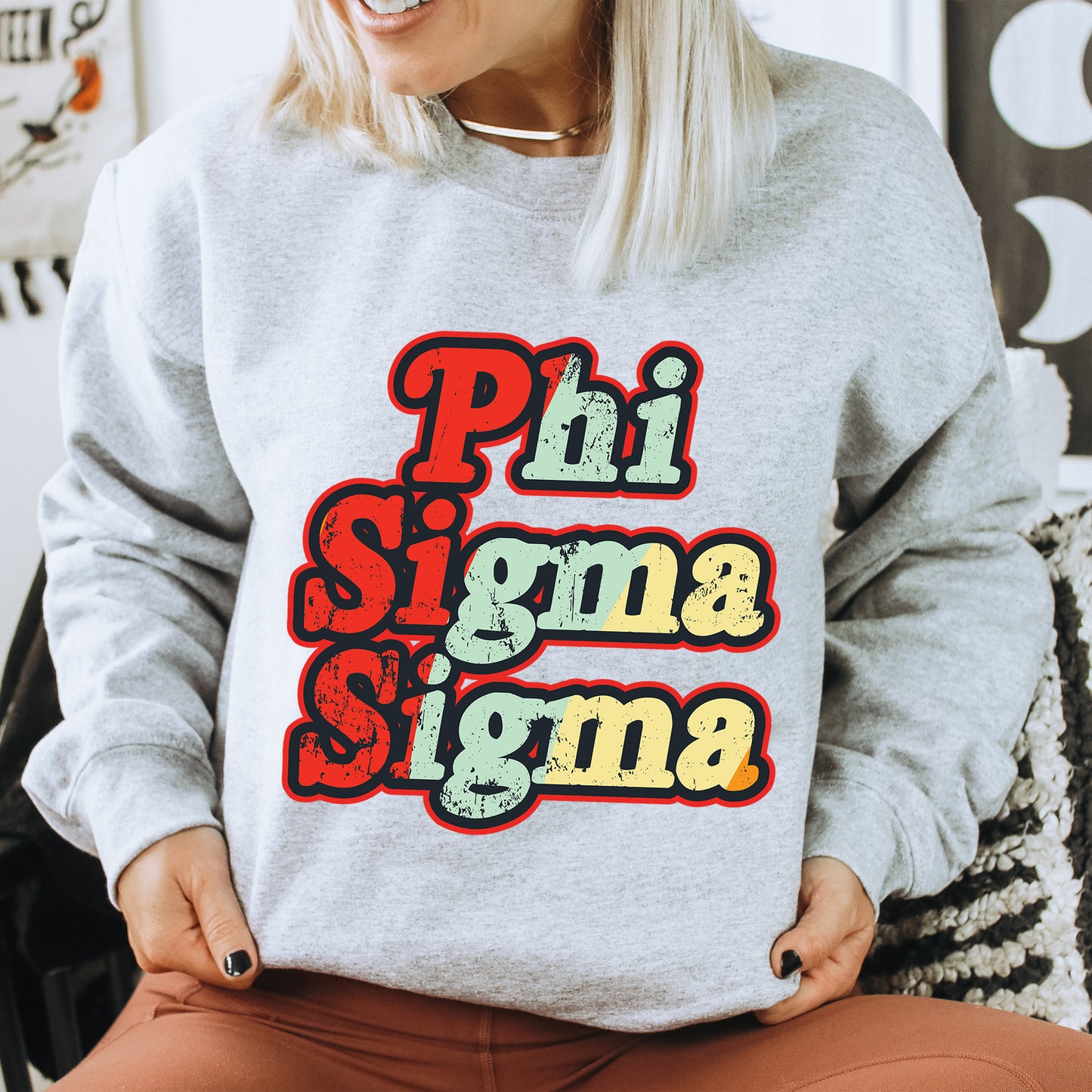 a woman sitting on a chair wearing a sweatshirt