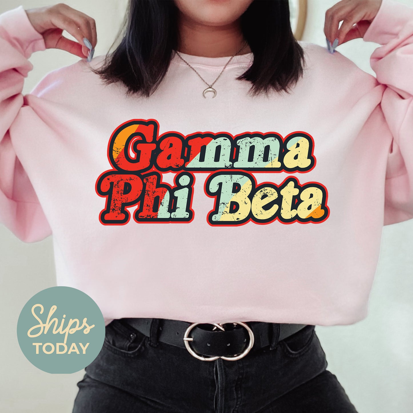 a woman wearing a pink sweatshirt with the words garmaa pii beta