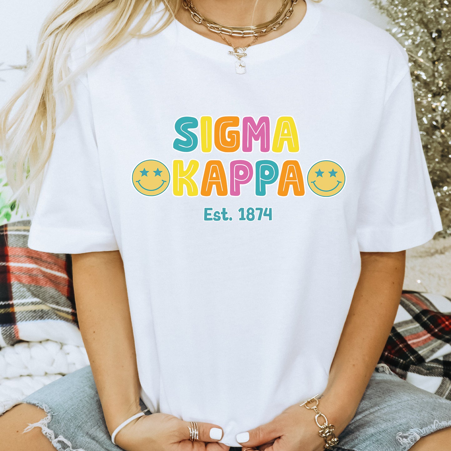 a woman wearing a white tshirt with the word sigma kappa on