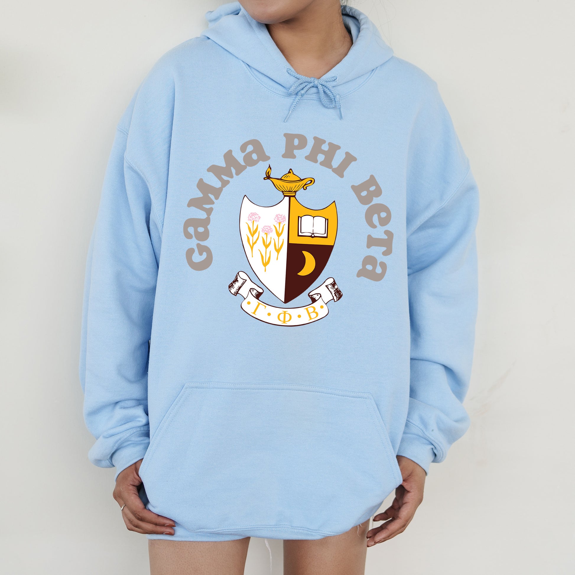 a person wearing a blue hoodie with a crown on it