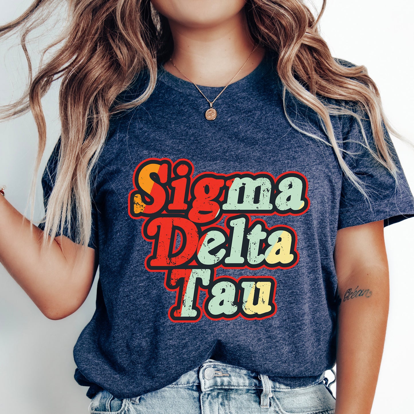 a woman wearing a t - shirt that says stigmaa delta tau