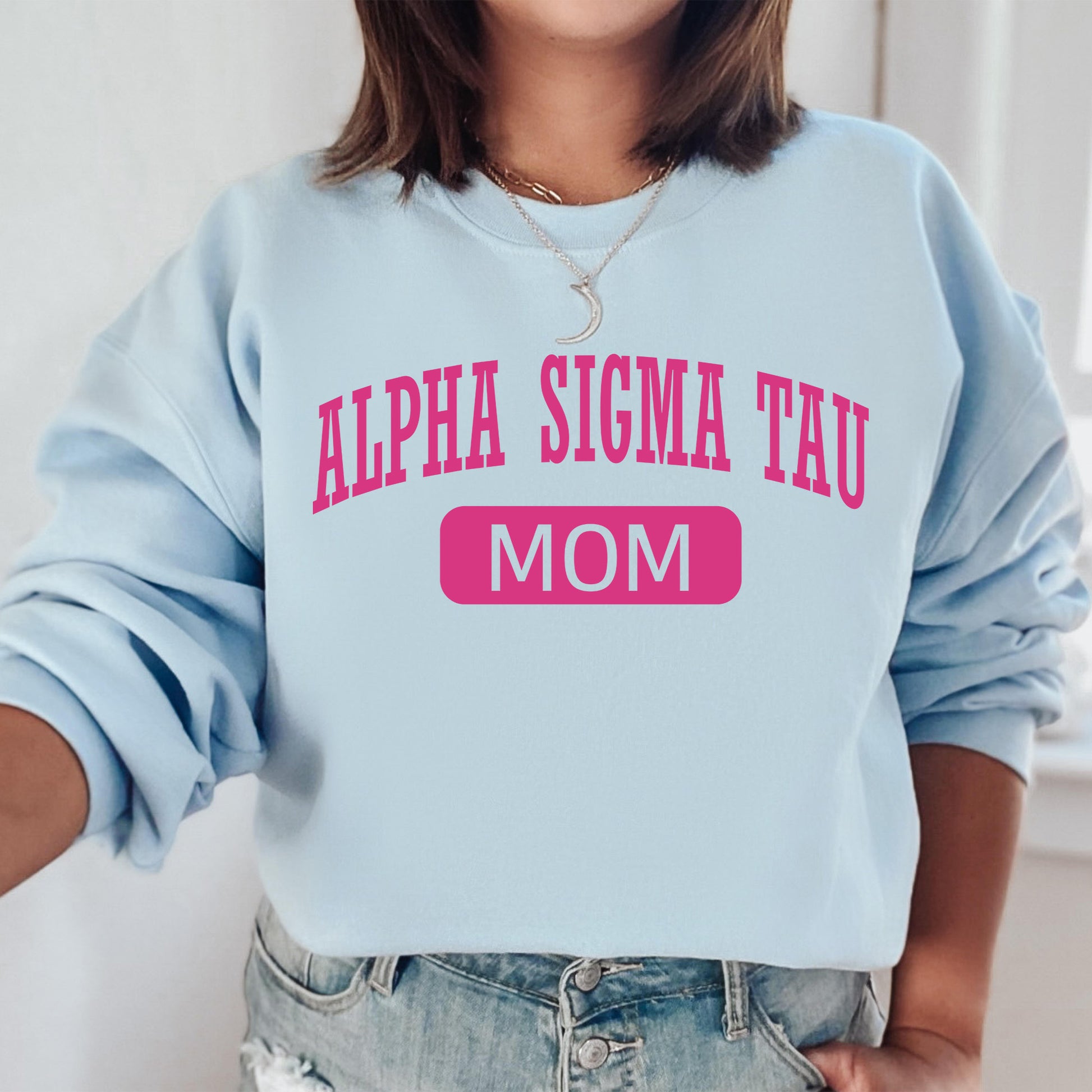 a woman wearing a blue sweatshirt with pink letters on it