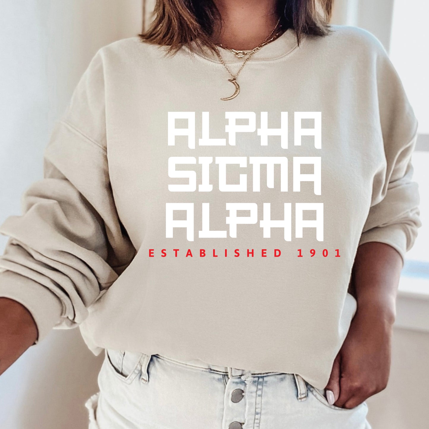 a woman wearing a sweatshirt that says, alphina, alphina established