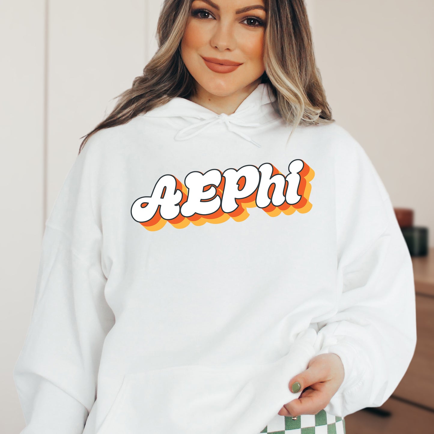 a woman wearing a white hoodie with the word pepni printed on it