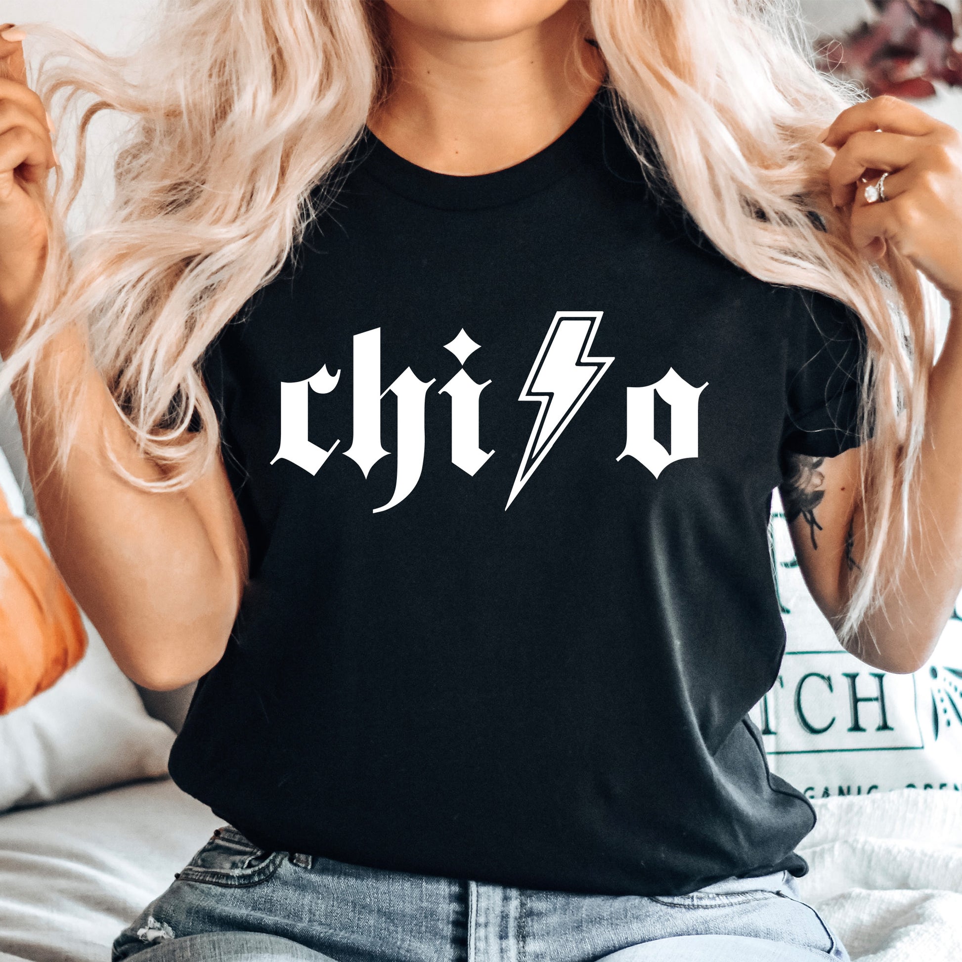 a woman wearing a black shirt with a lightning bolt on it