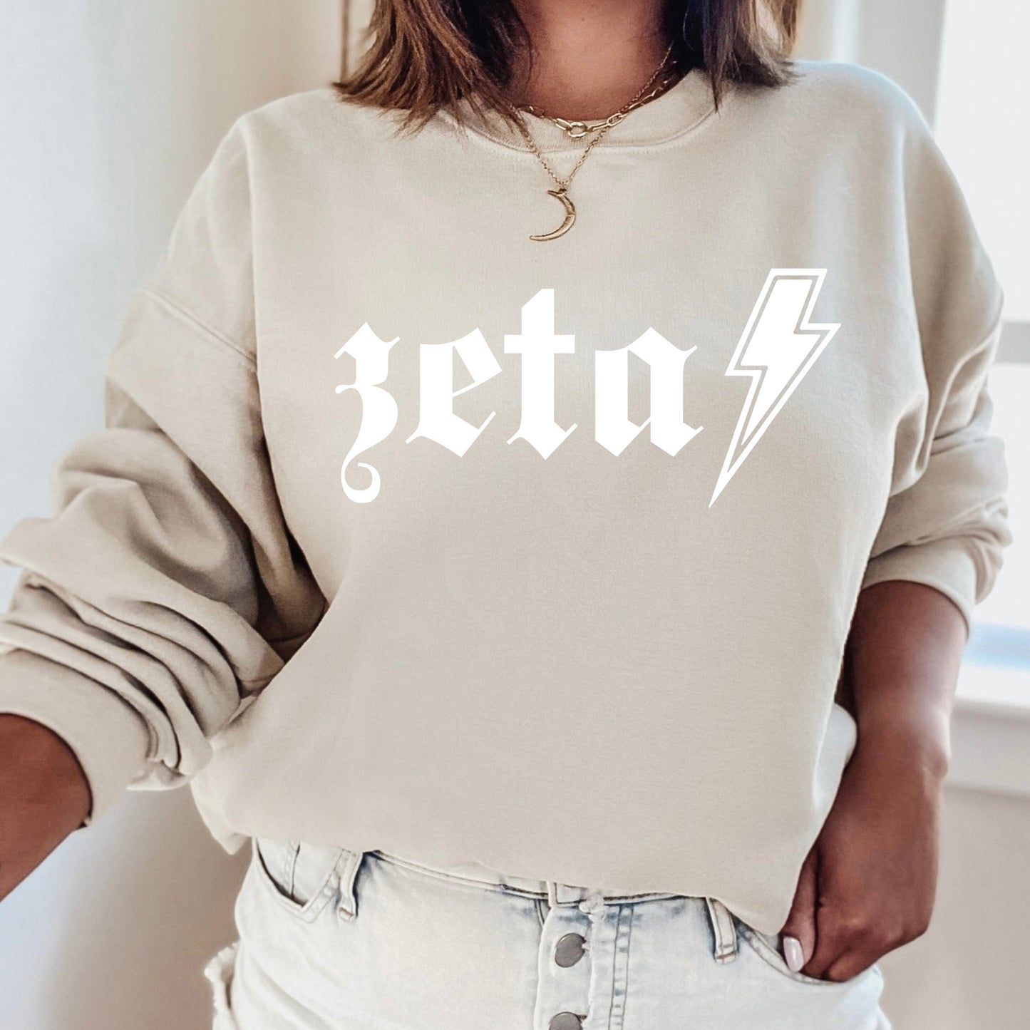 a woman wearing a sweatshirt with a lightning bolt on it