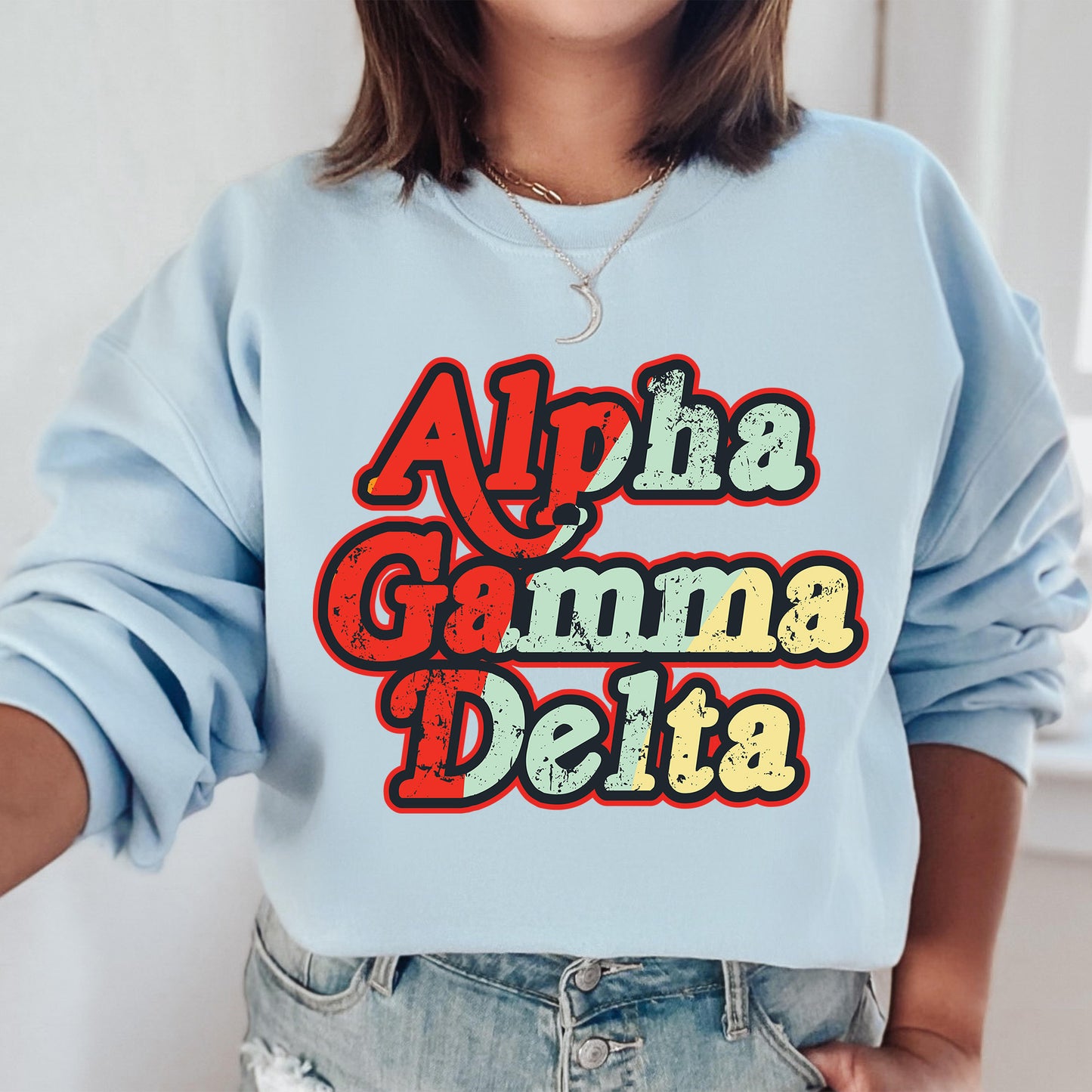 a woman wearing a blue sweatshirt with the words aloha gama delta printed