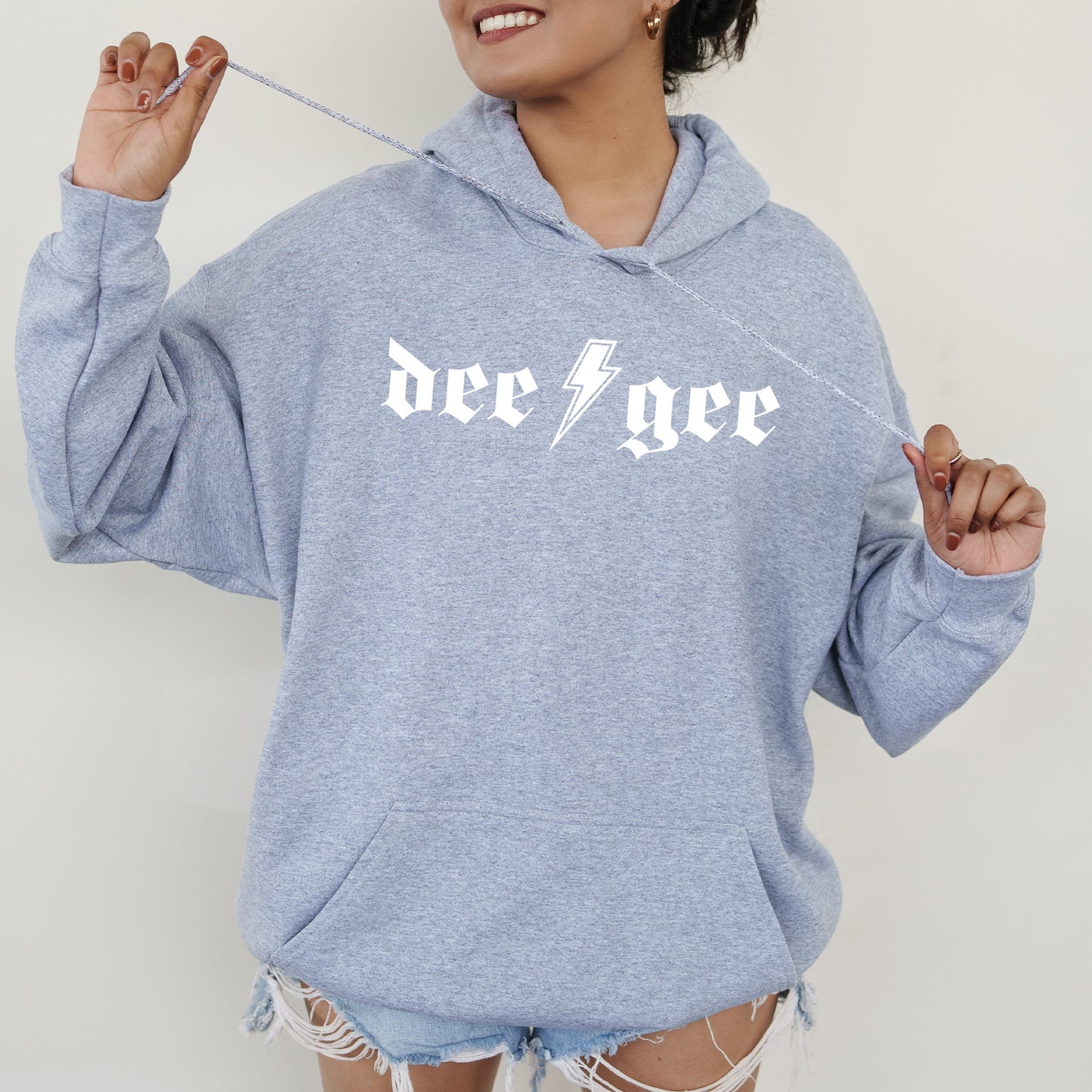 a woman wearing a blue sweatshirt with a lightning bolt on it