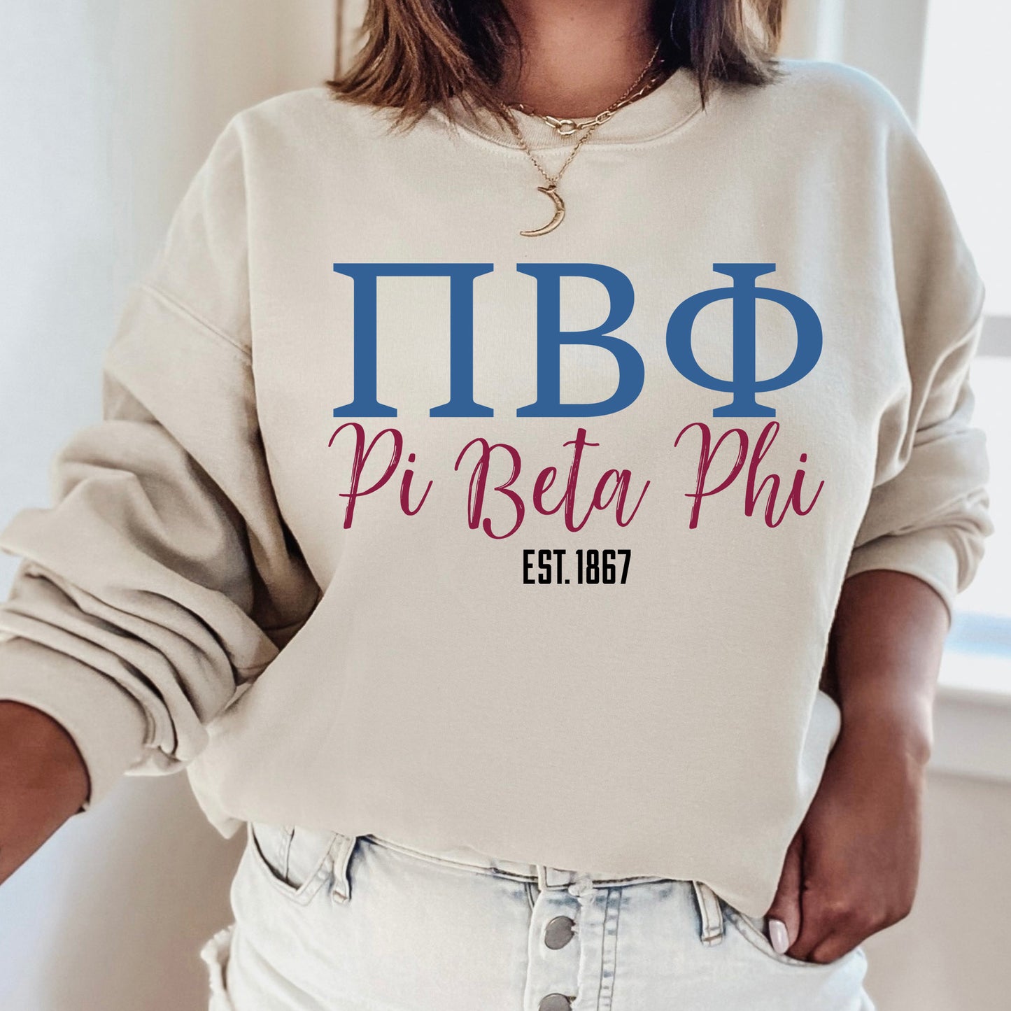 a woman wearing a sweatshirt that says pi beta phi
