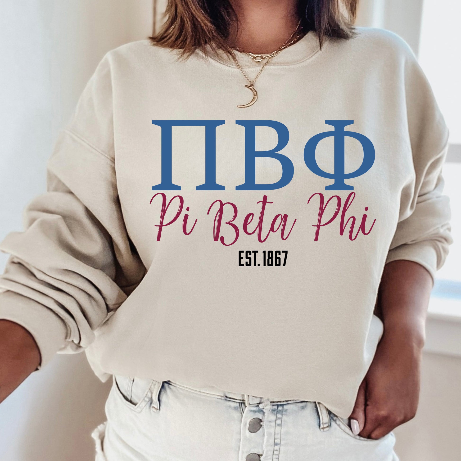a woman wearing a sweatshirt that says pi beta phi