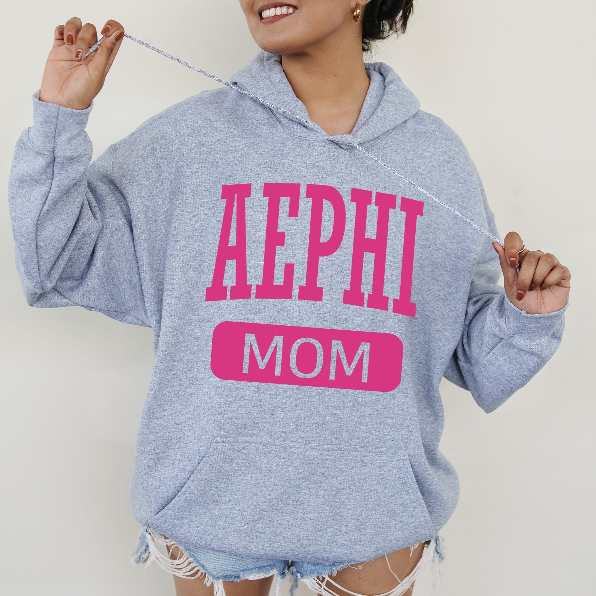 a woman wearing a sweatshirt that says aephh mom