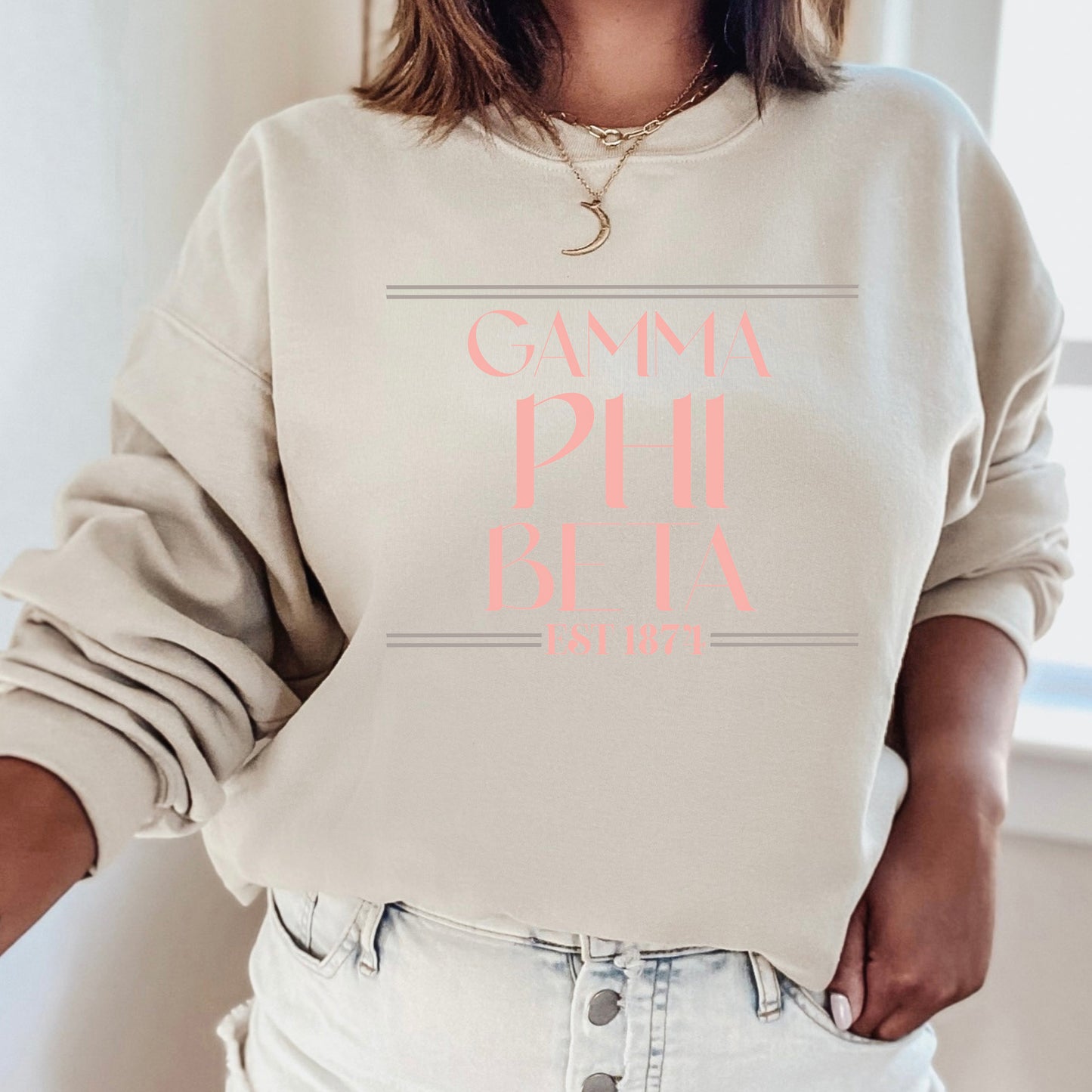 a woman wearing a white sweatshirt with pink lettering