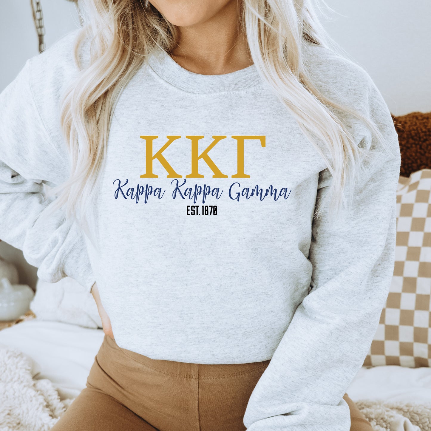 a woman wearing a sweatshirt that says kkt, rappa rappa gouna