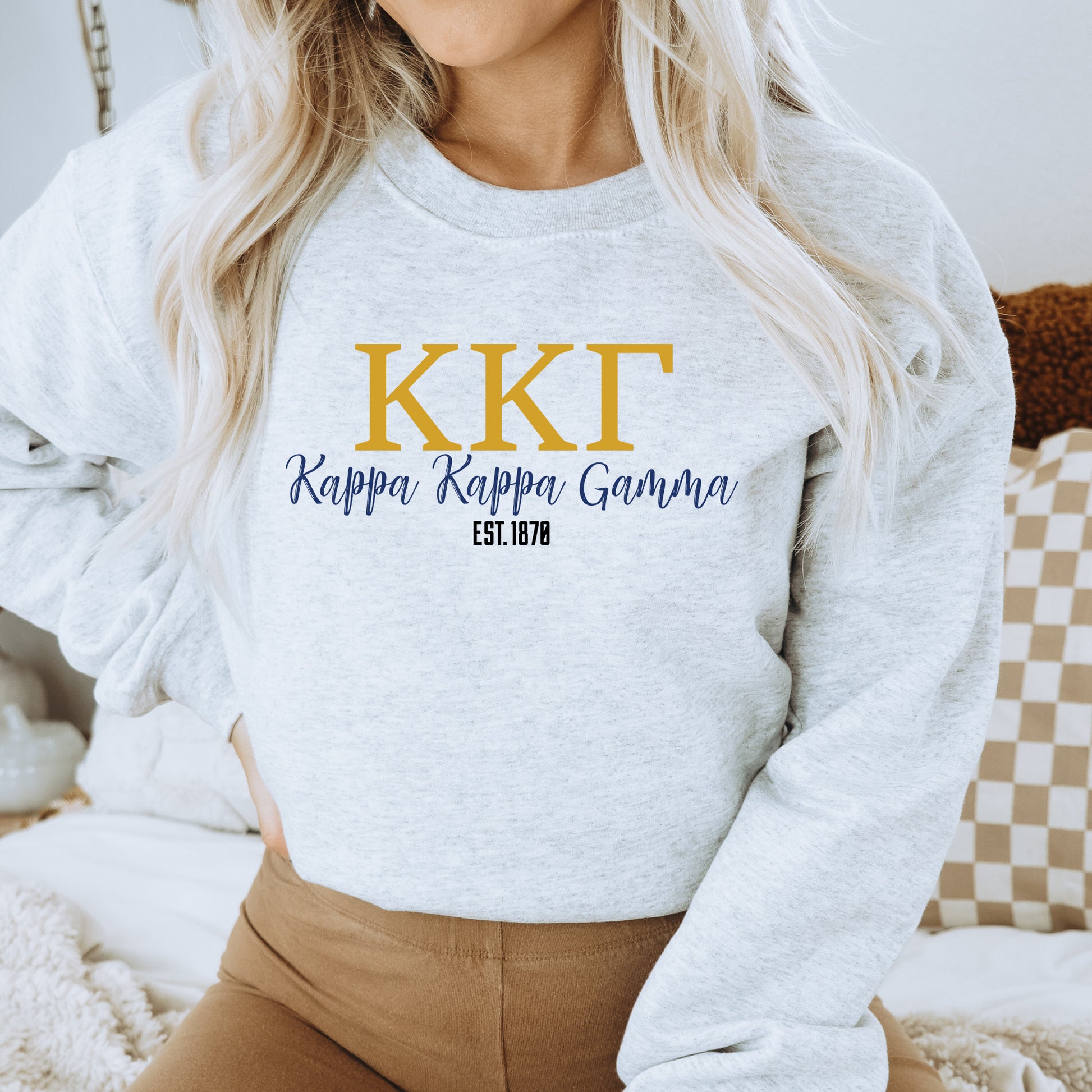a woman wearing a sweatshirt that says kkt, rappa rappa gouna