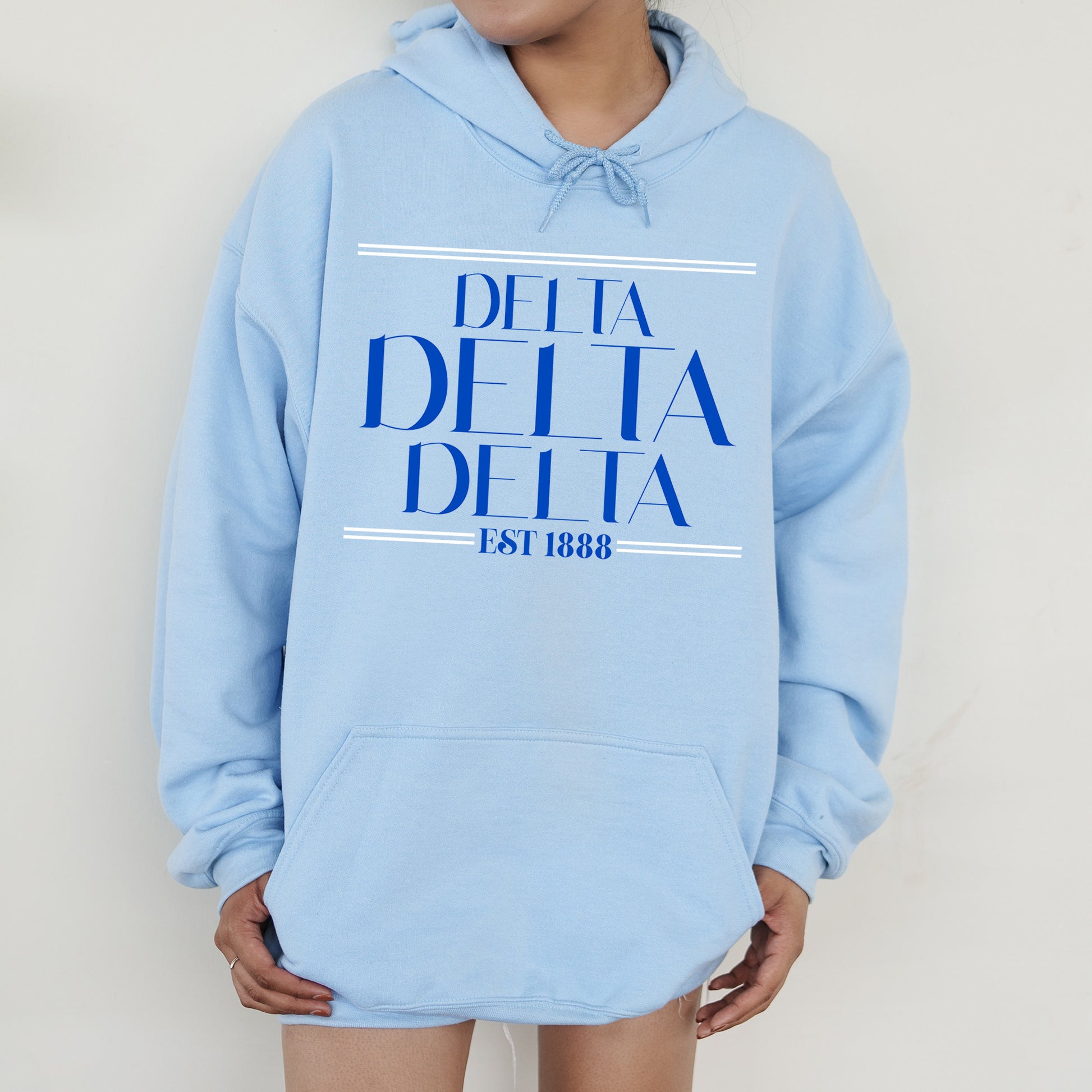 a woman wearing a blue delta delta hoodie