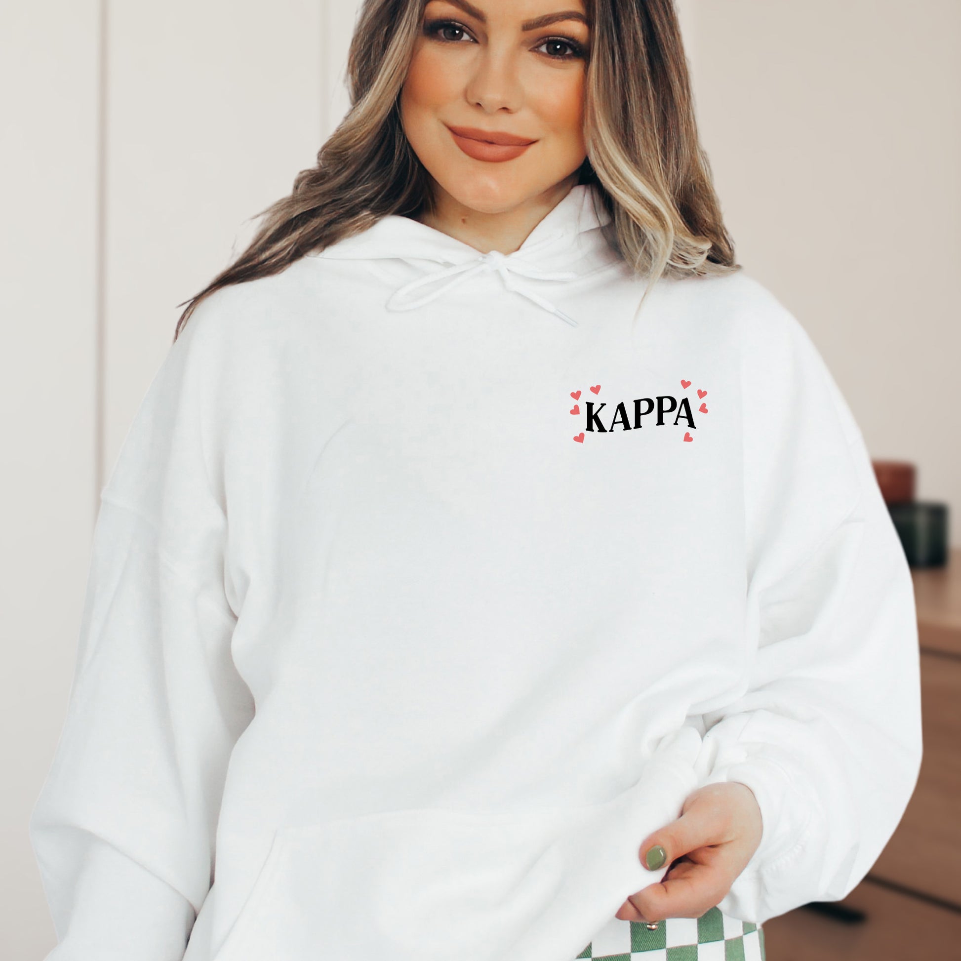 a woman wearing a white kapa hoodie