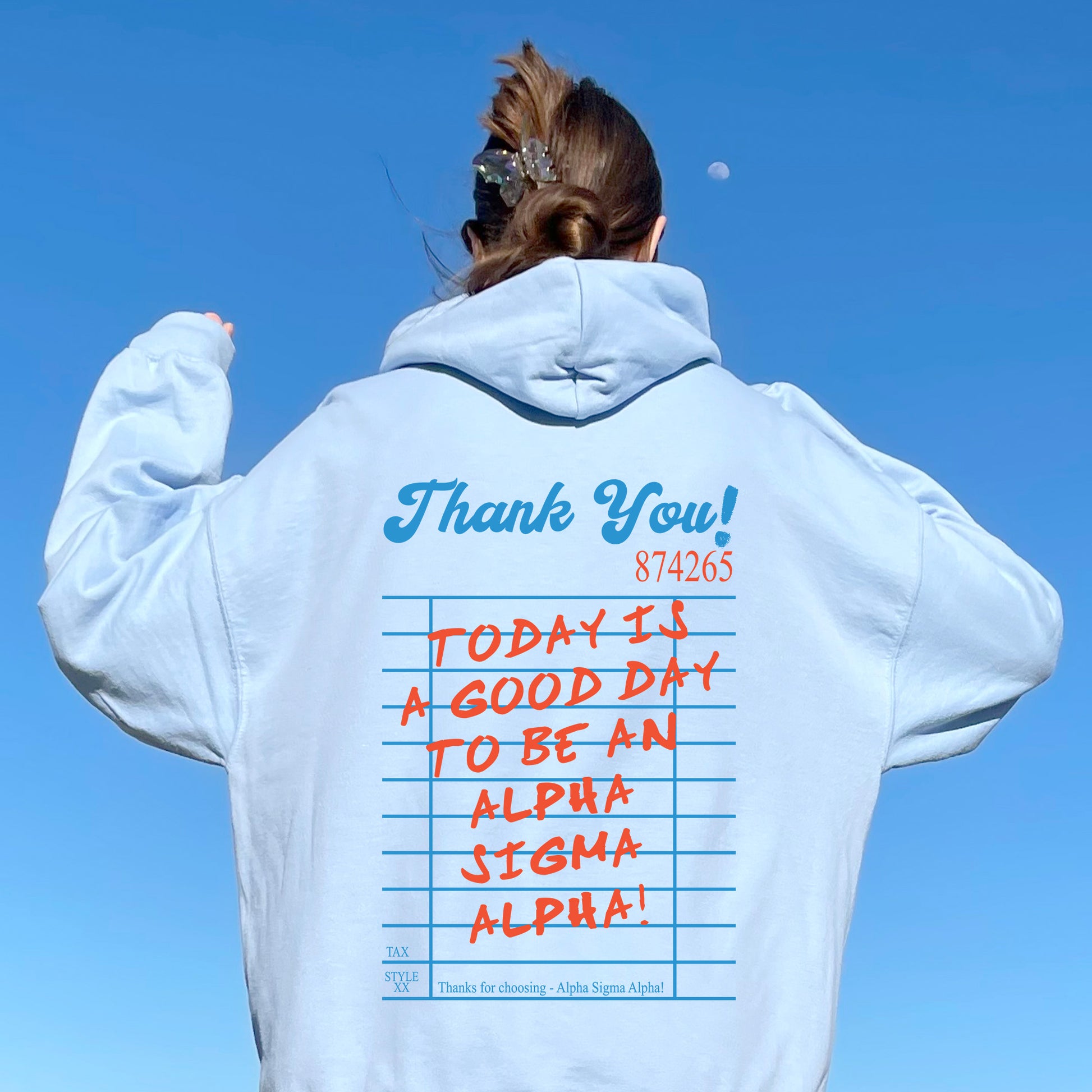 a woman wearing a white hoodie with writing on it