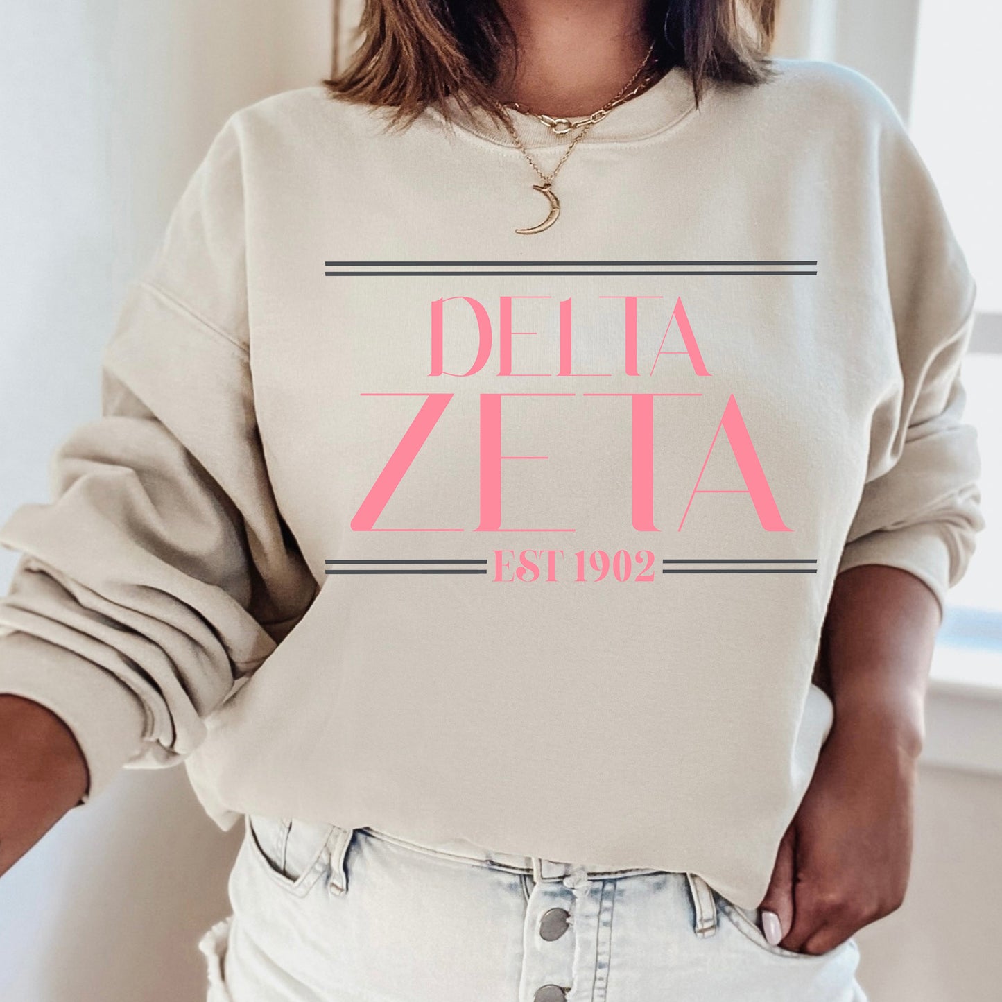 a woman wearing a sweatshirt that says delta delta