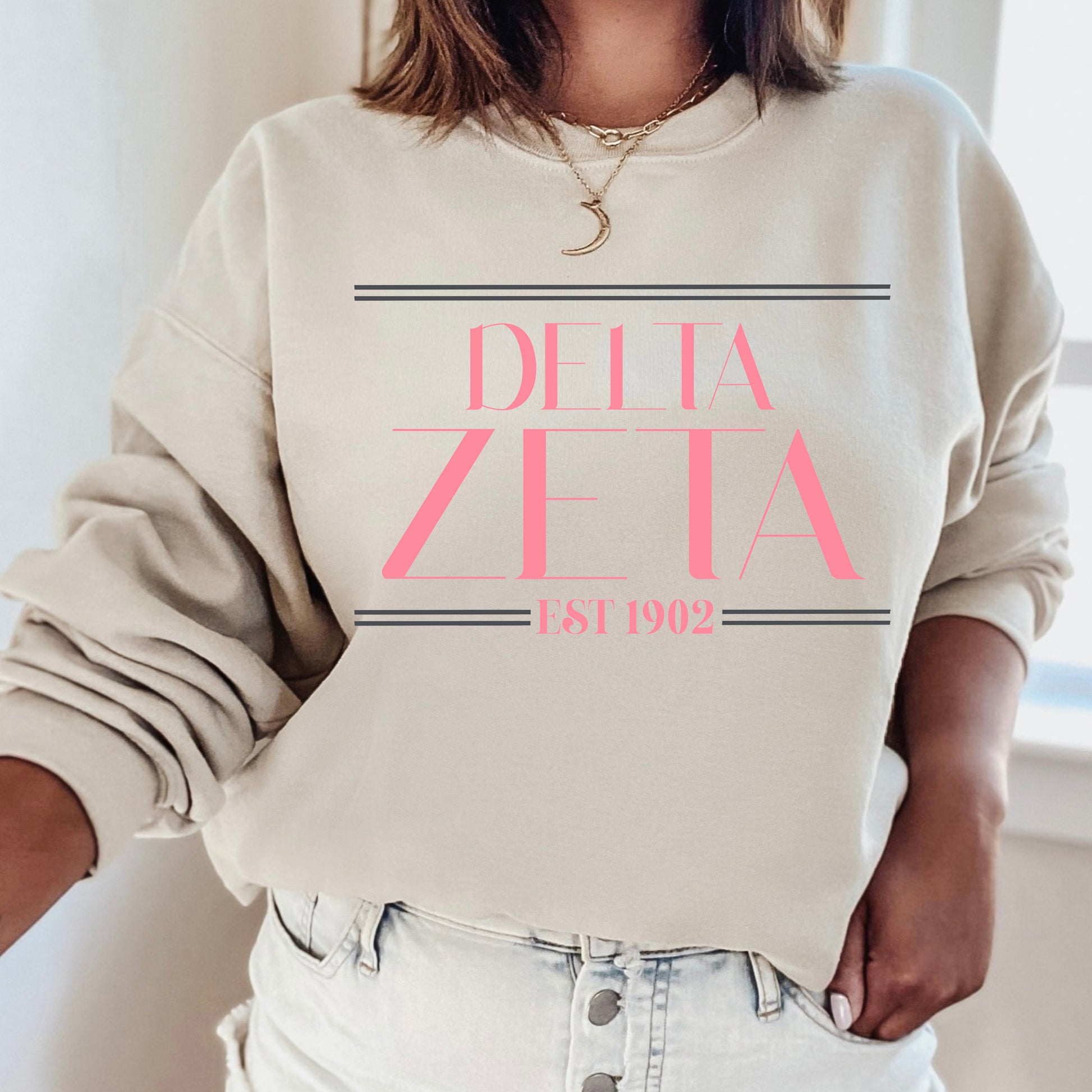 a woman wearing a sweatshirt that says delta delta