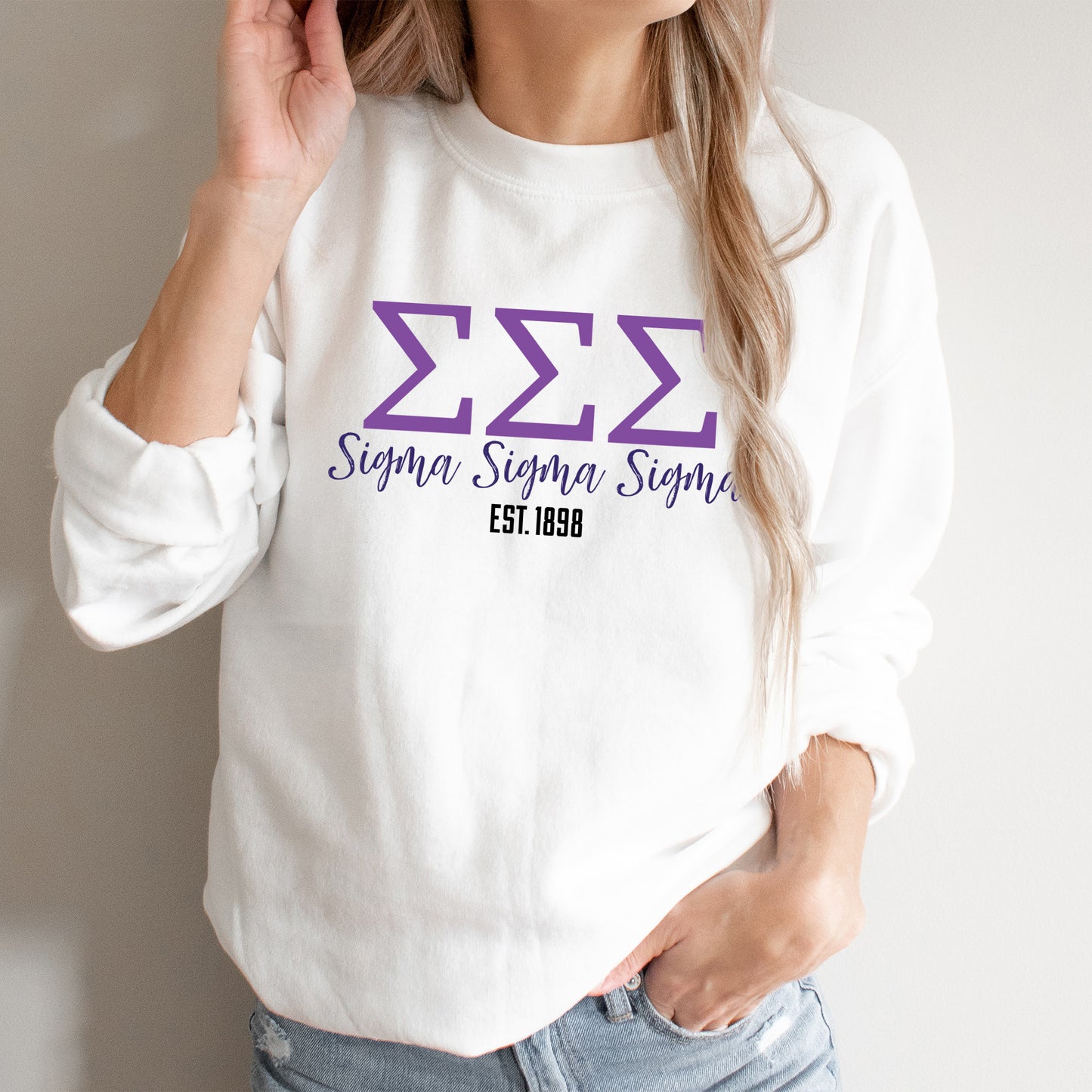 a woman wearing a white sweater with a purple zzz logo on it
