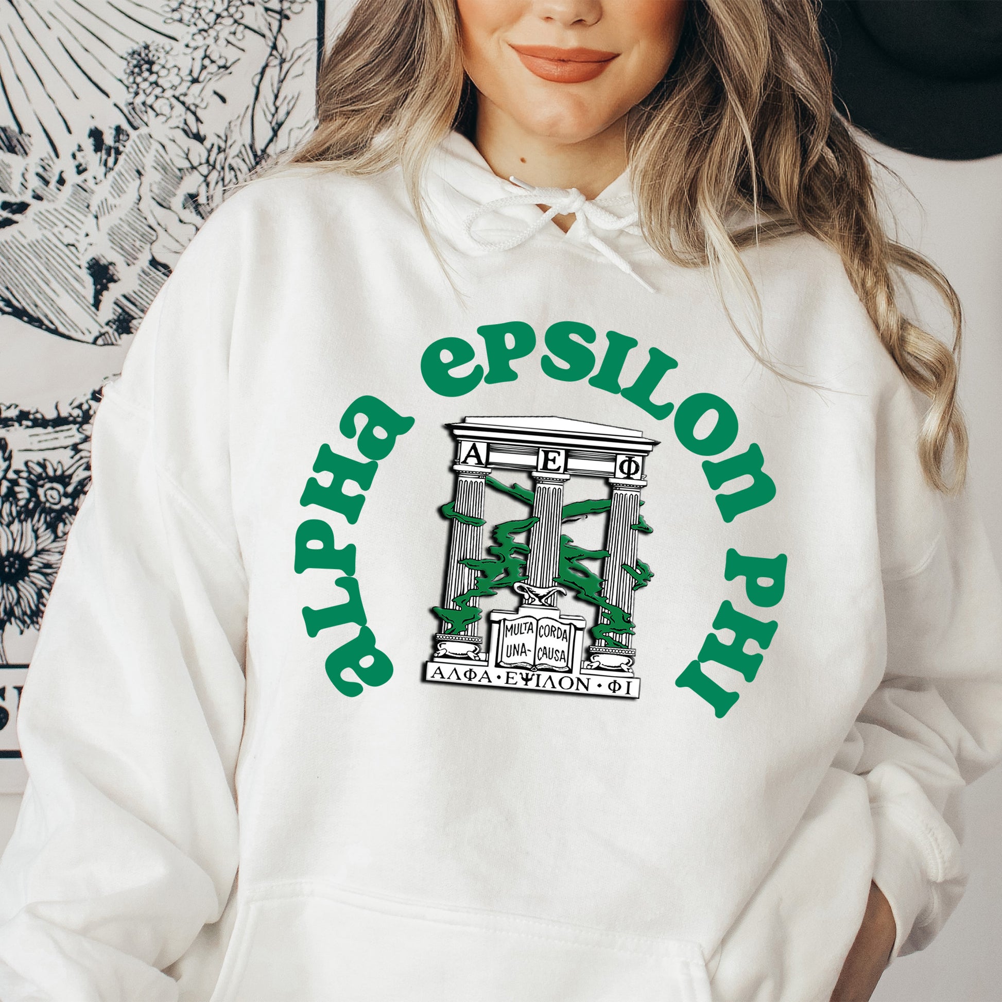 a woman wearing a white hoodie with green lettering