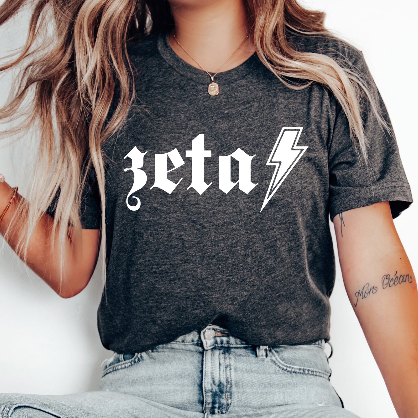 a woman wearing a black shirt with a lightning bolt on it