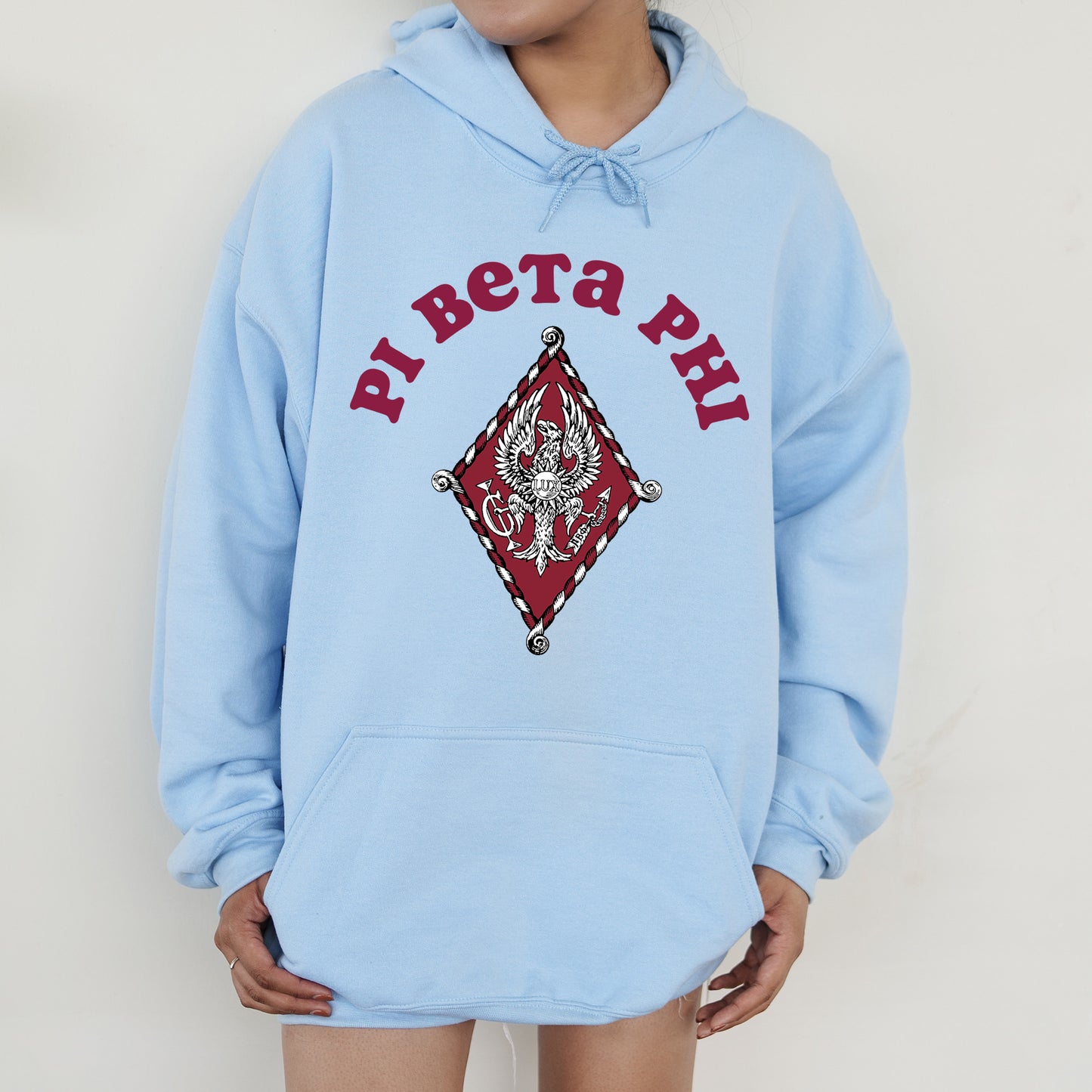 a person wearing a blue hoodie with a picture of a demon on it