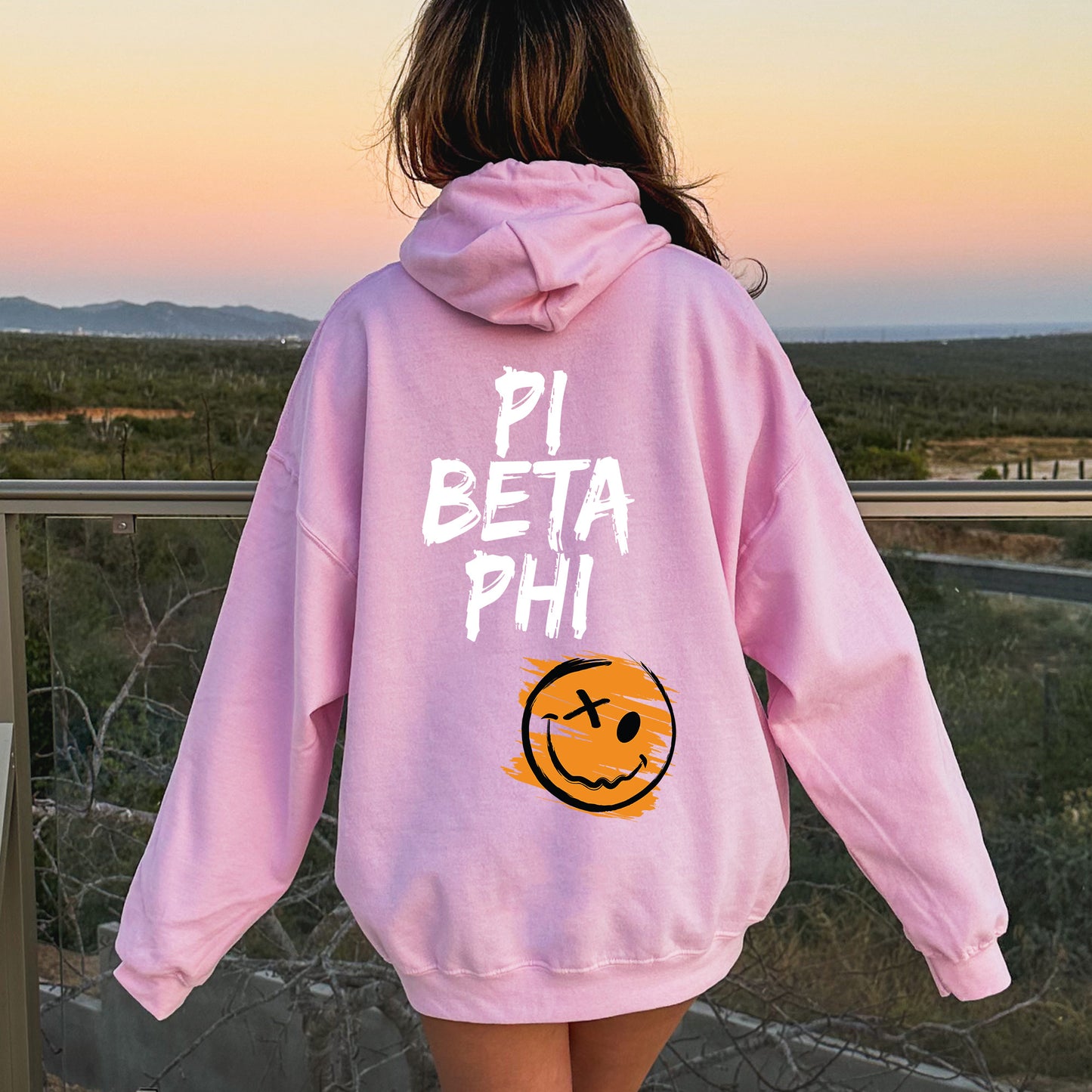 a girl in a pink hoodie that says pi beta phi