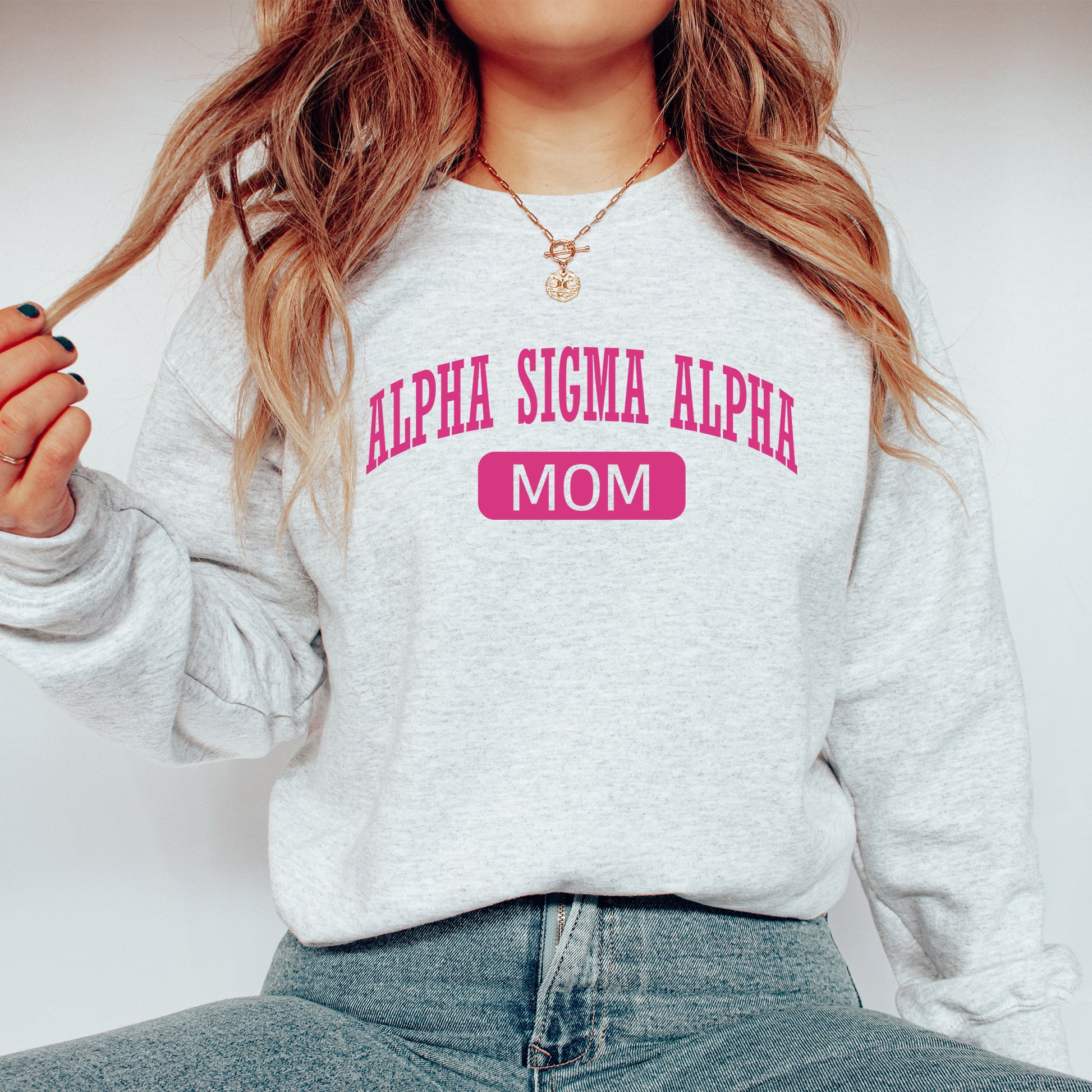 a woman wearing a sweatshirt that says,'alpera sigma al