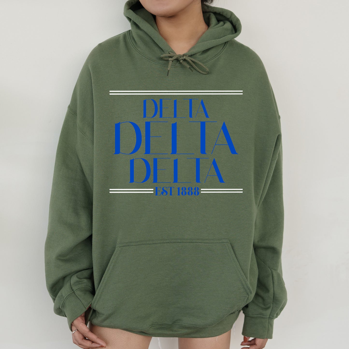 a woman wearing a green hoodie with blue letters on it