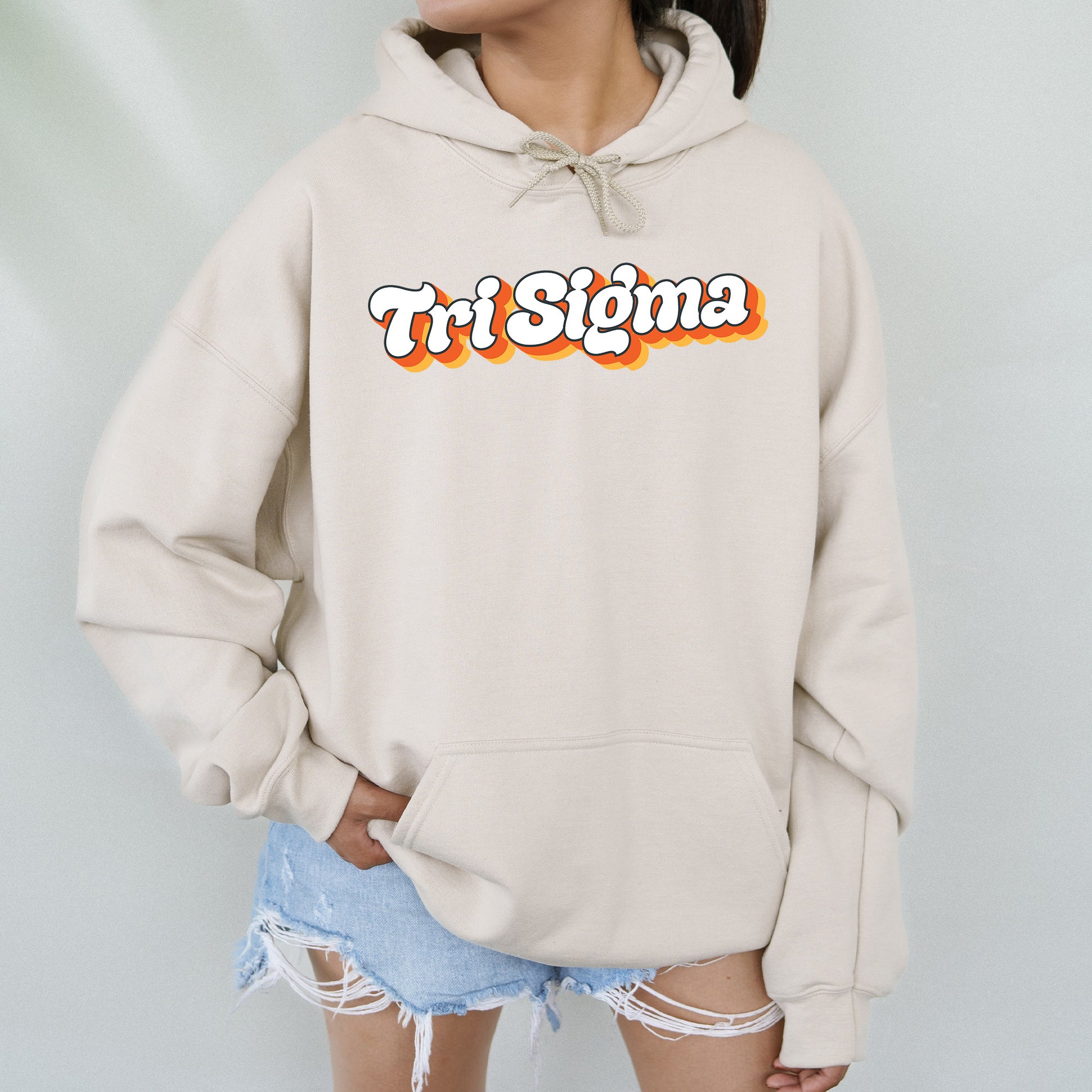a woman wearing a white sweatshirt with the word tri stigma on it