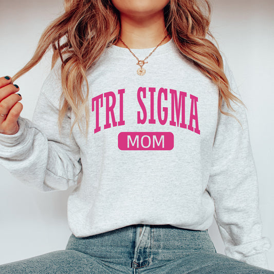 a woman wearing a sweatshirt that says tri stigma mom