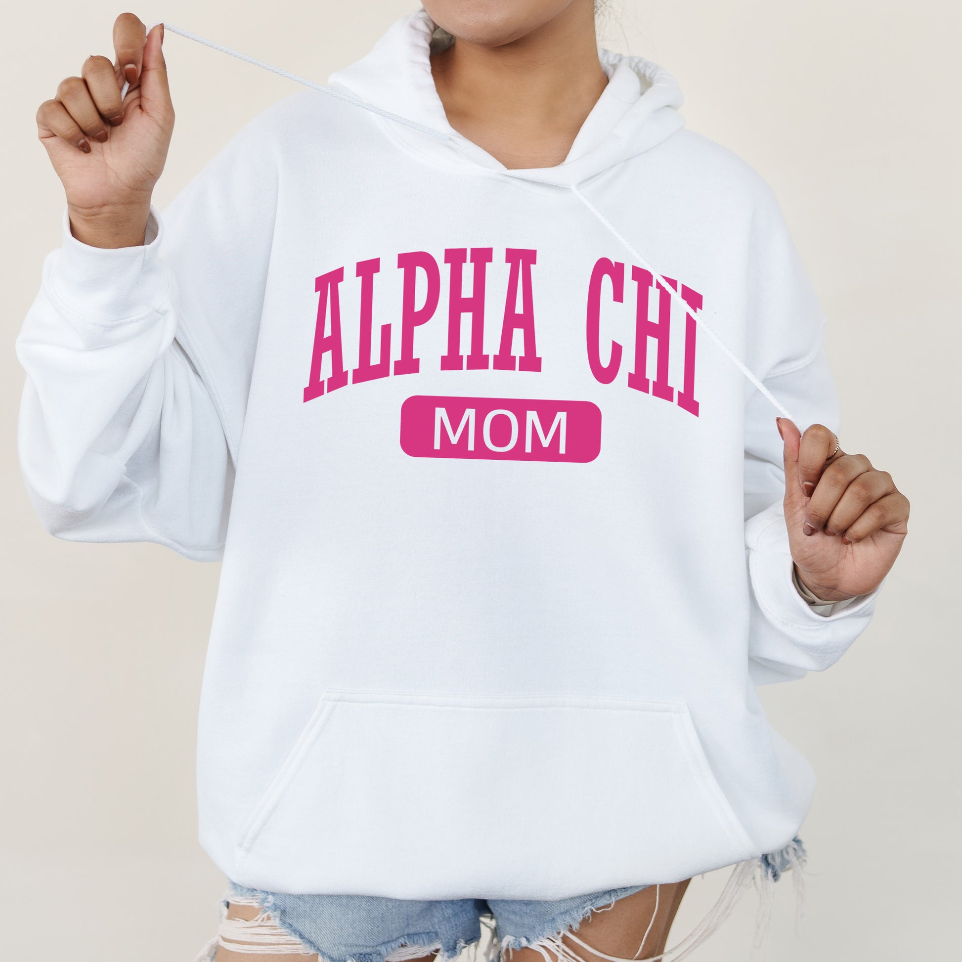 a woman wearing a white hoodie with pink letters on it