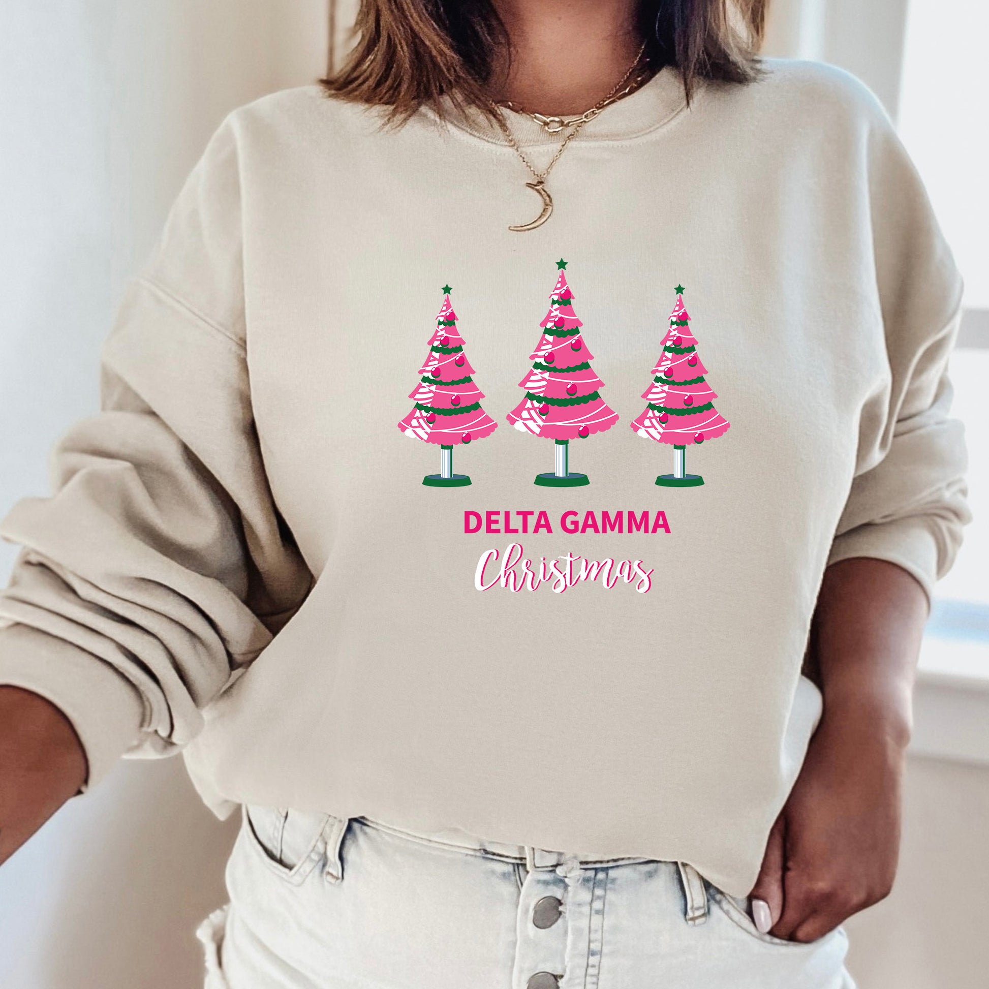 a woman wearing a sweatshirt with christmas trees on it