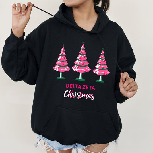 a woman wearing a black hoodie with pink trees on it