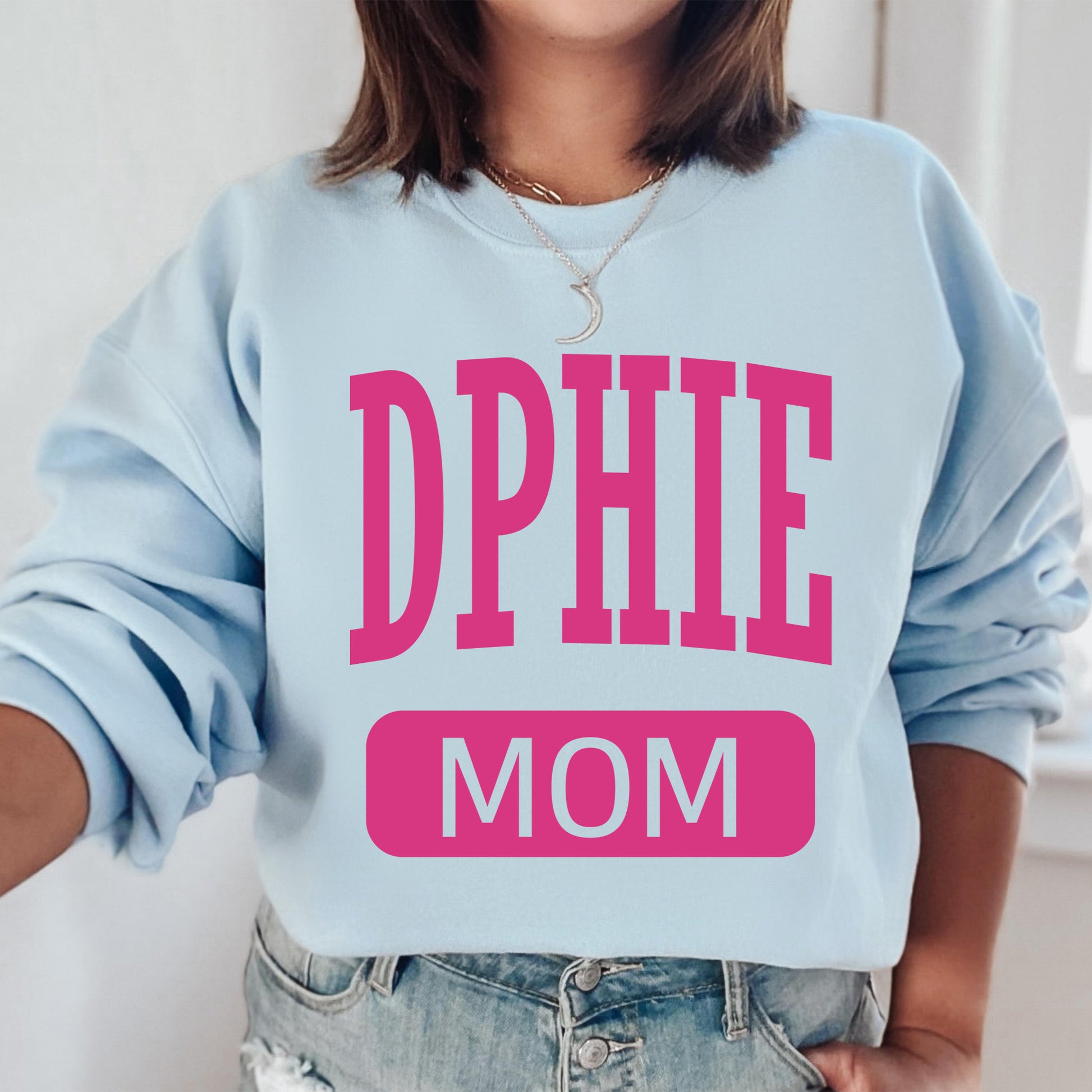 a woman wearing a sweatshirt that says dppie mom
