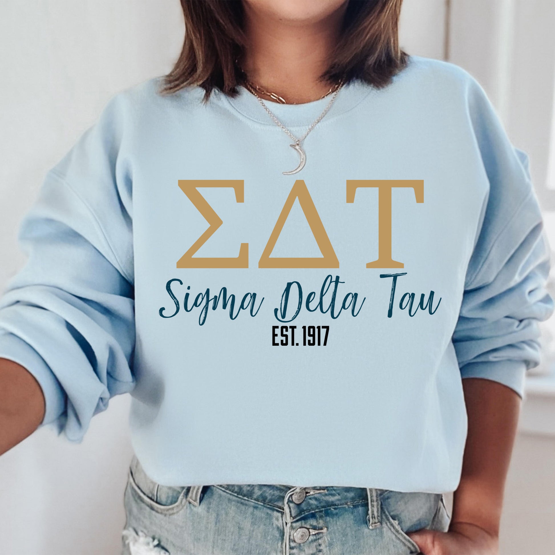 a woman wearing a blue sweatshirt with the letters zat on it