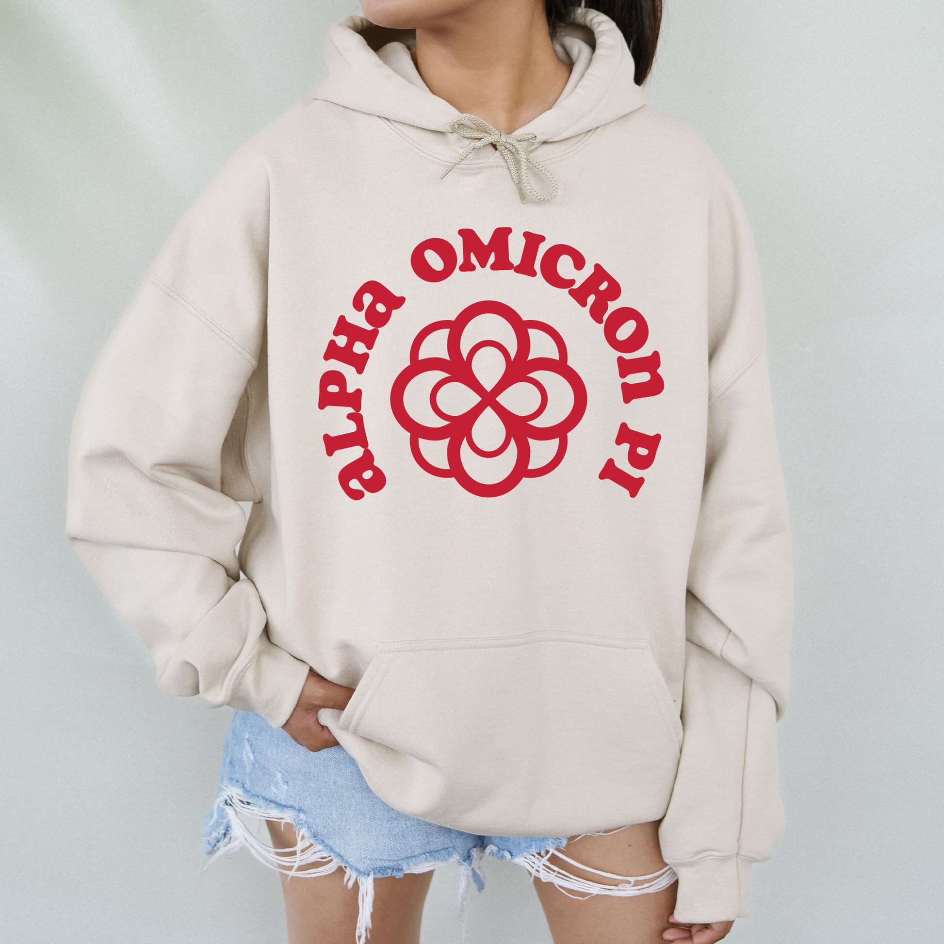 a woman wearing a white hoodie with a red logo on it