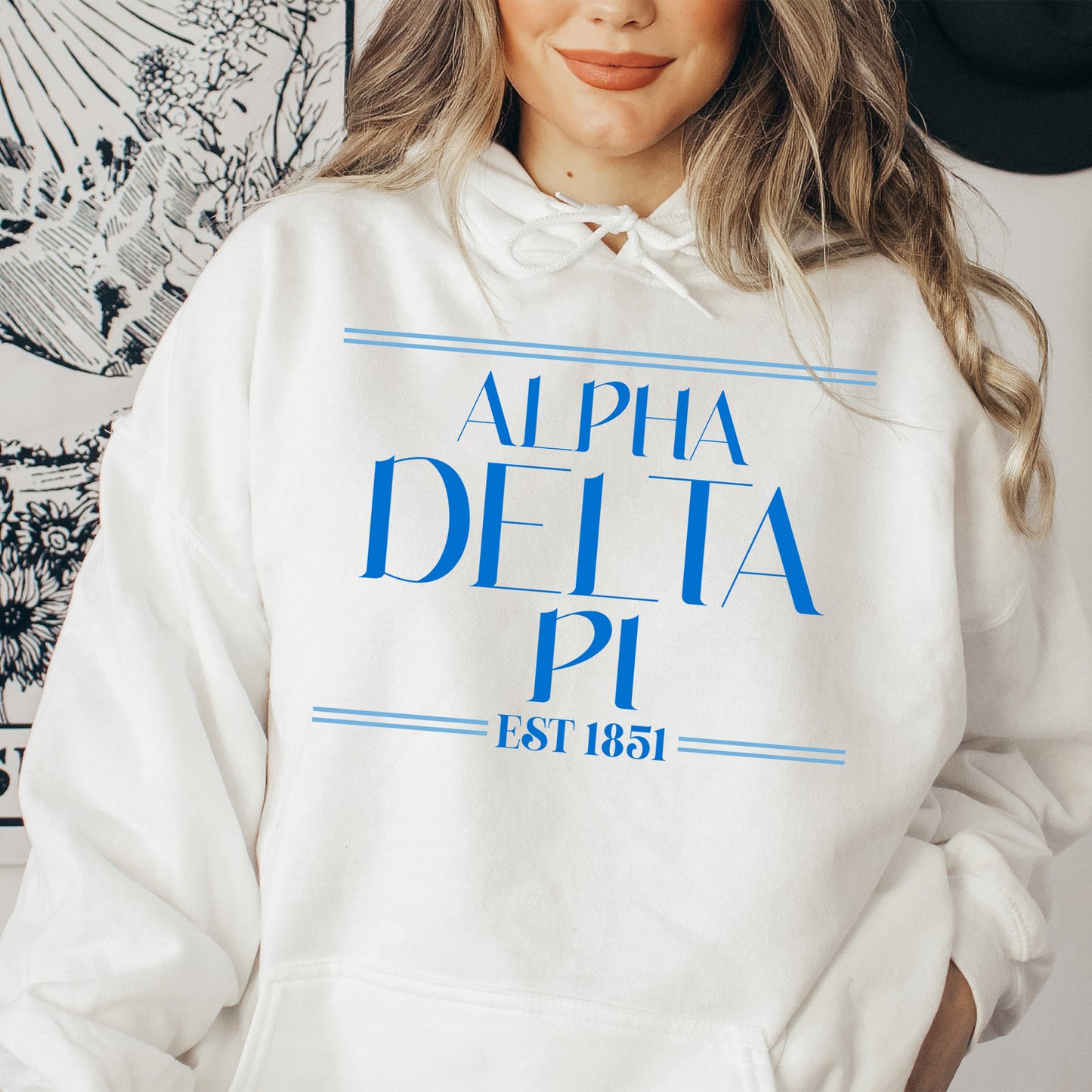 a woman wearing a white sweatshirt with a blue print on it