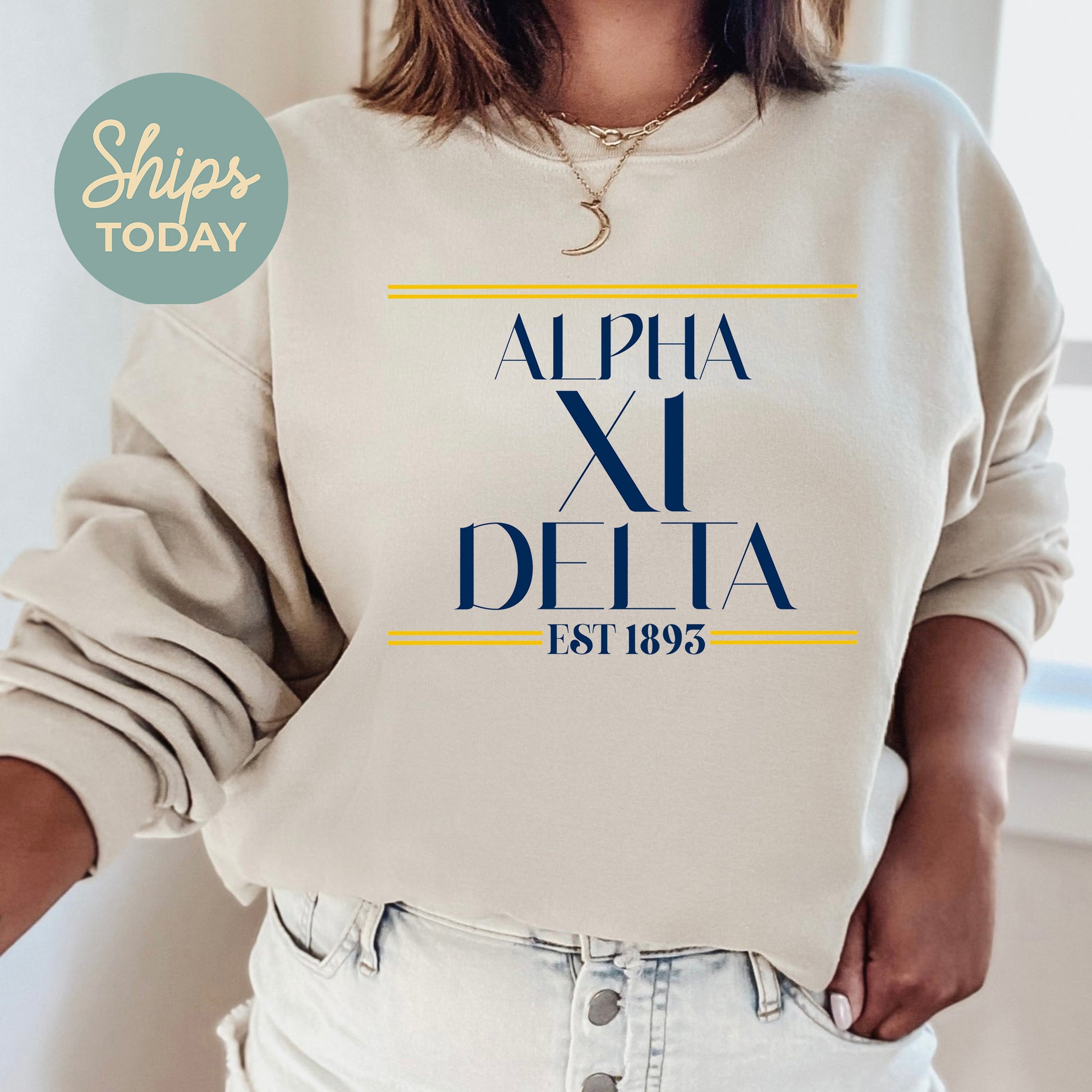a woman wearing a sweatshirt with the words alpha la delta printed on it