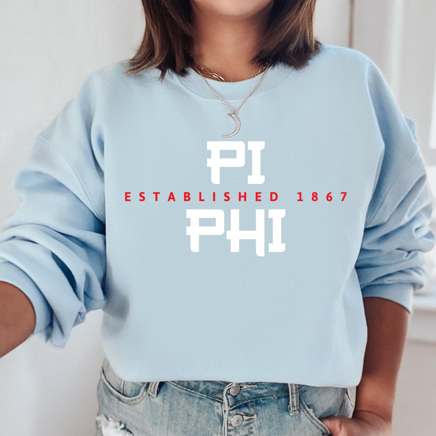 a woman wearing a blue sweatshirt with the words phi printed on it