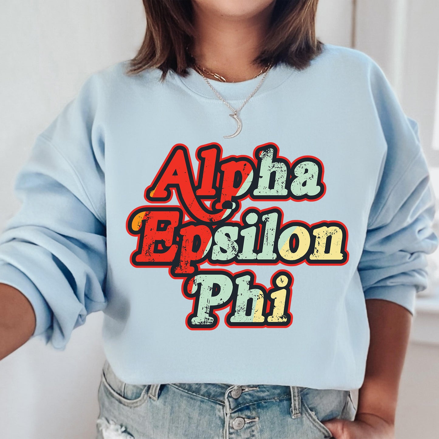 a woman wearing a blue sweatshirt with the words aloha, epsion,