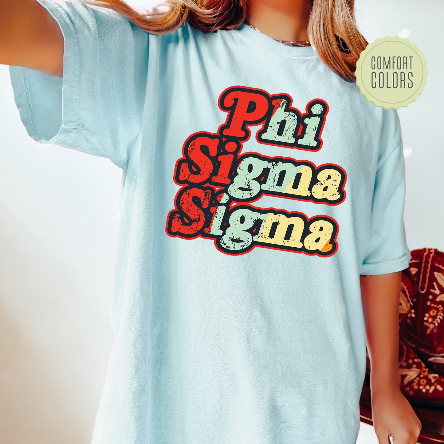 a young girl wearing a phi sigma shirt