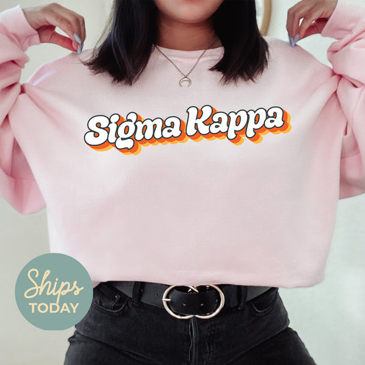 a woman wearing a pink sweater with the word stigma kapa on it