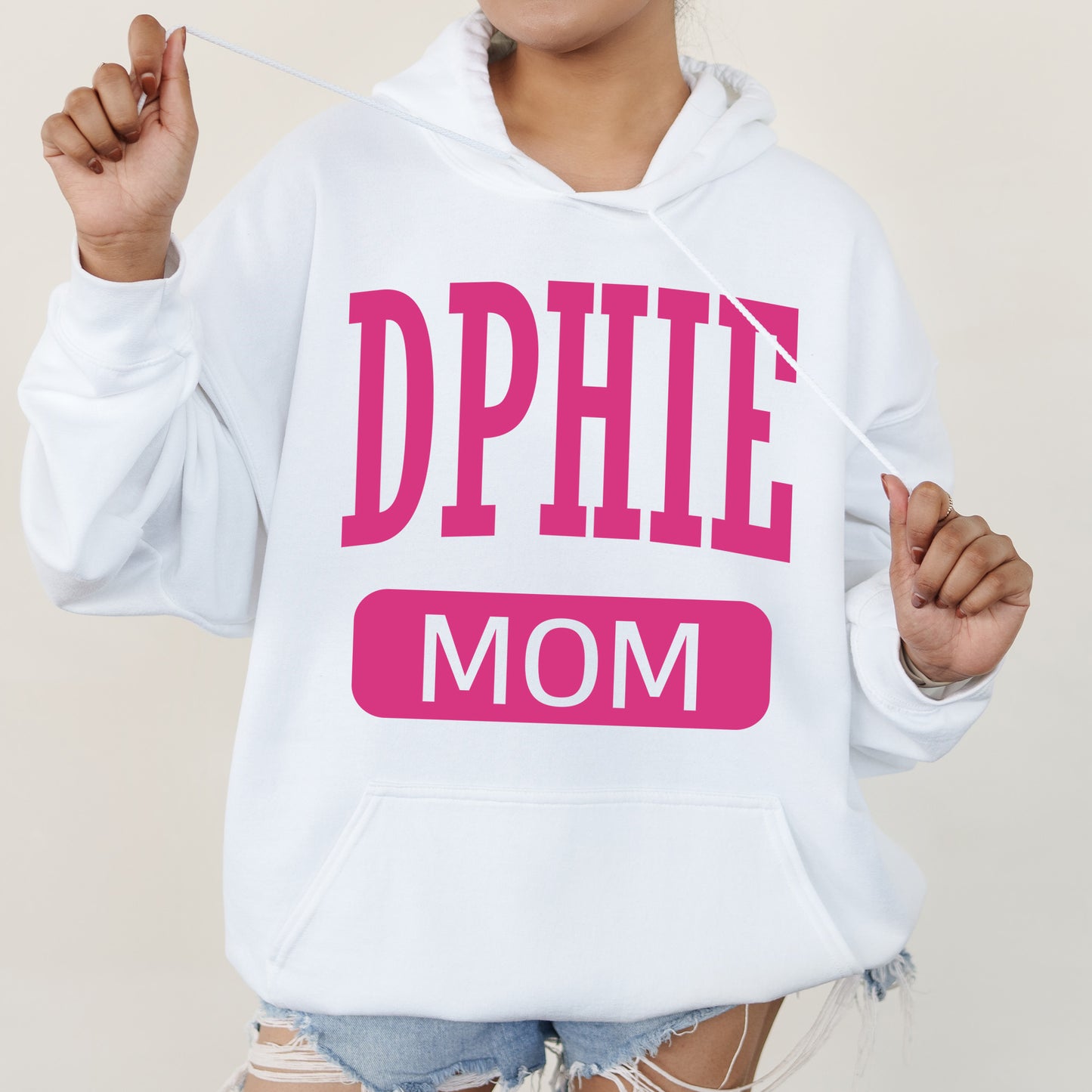 a woman wearing a white hoodie that says dppie mom