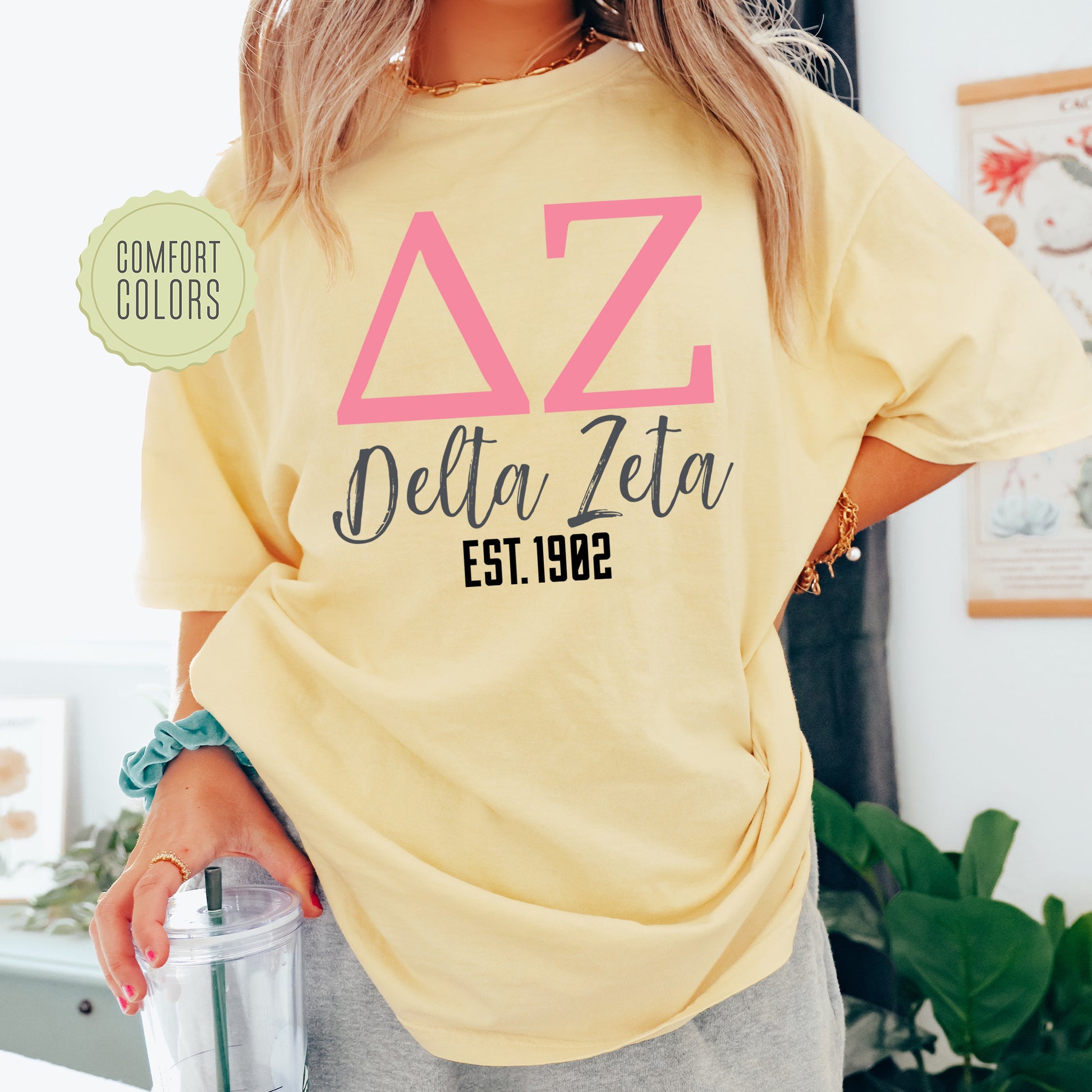 a woman wearing a yellow delta delta shirt