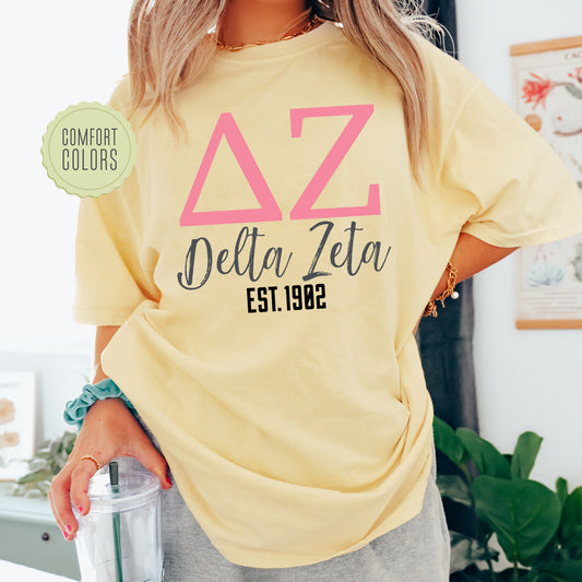 a woman wearing a yellow delta delta shirt